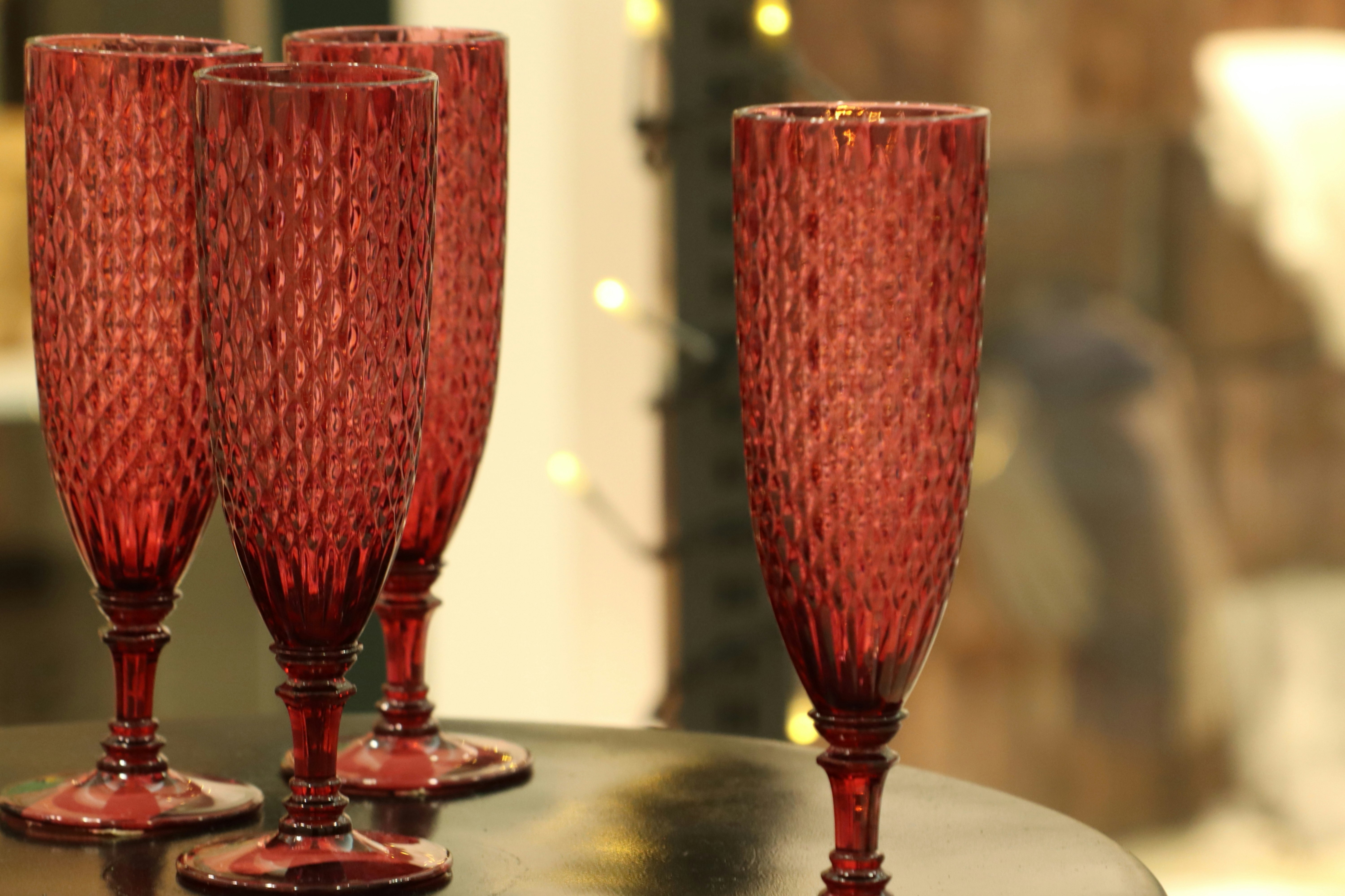 Red champagne glasses lined up on a table