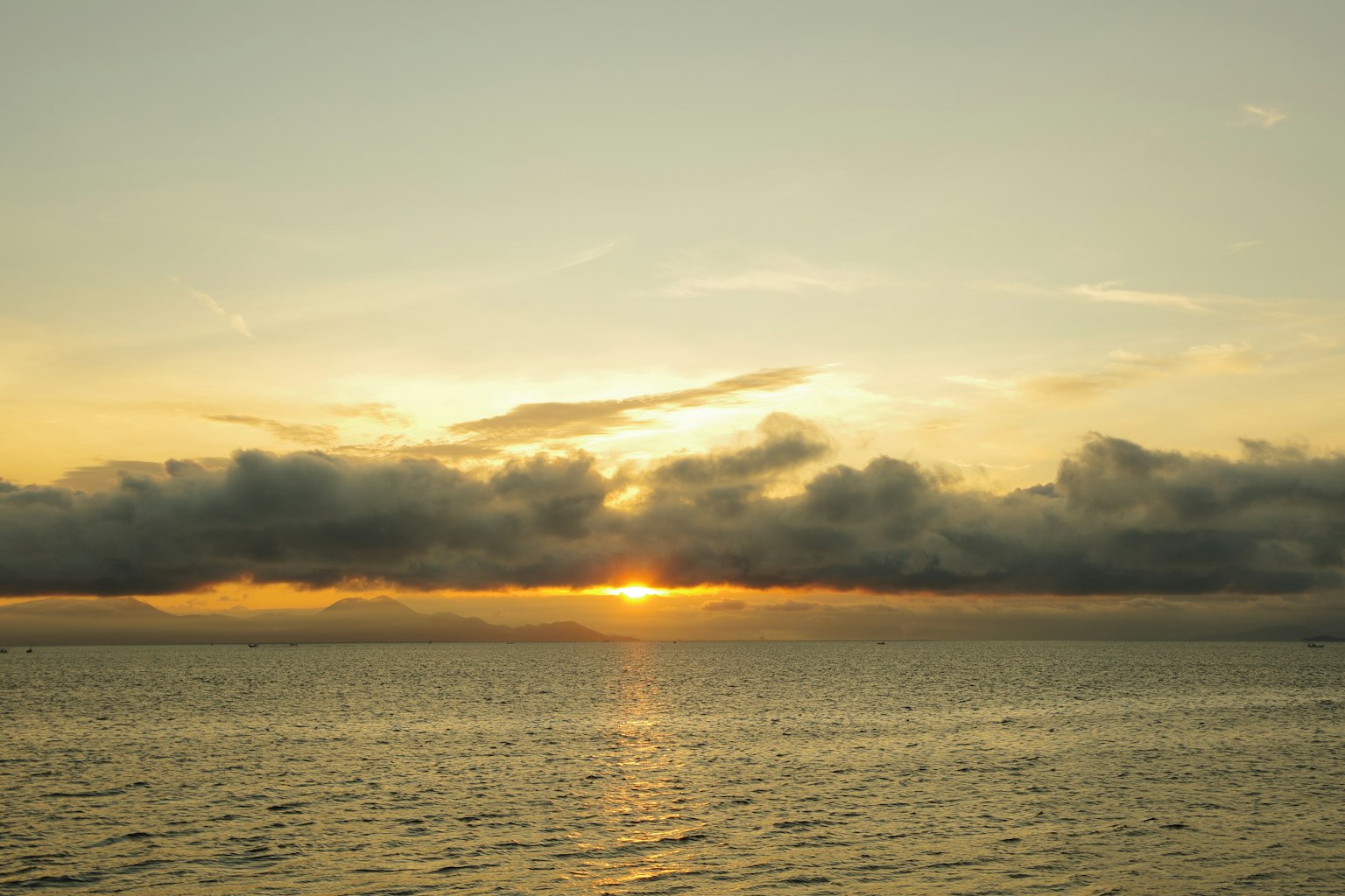 Sunset over the ocean with clouds