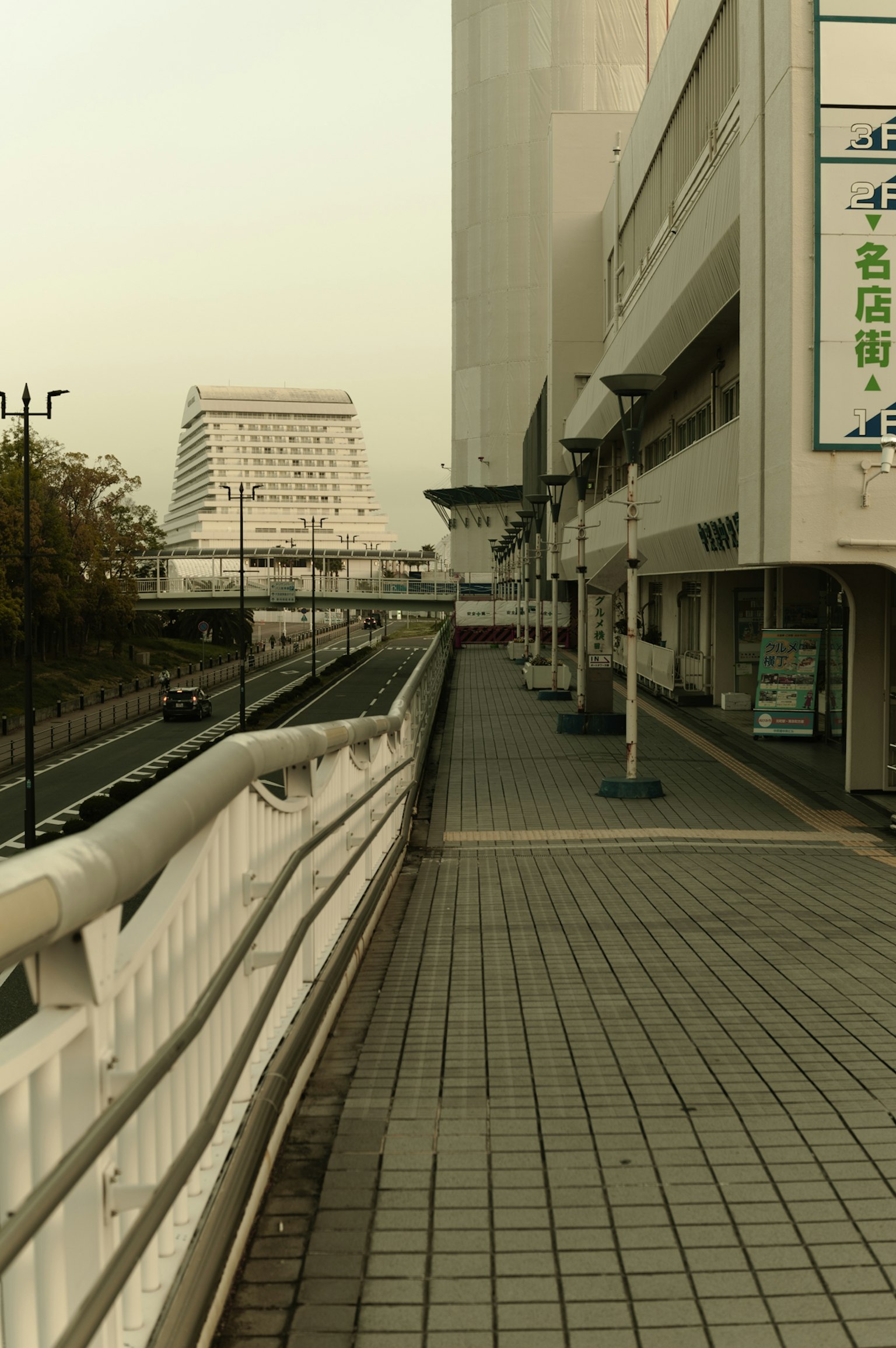 Urban sidewalk with buildings and distant architecture