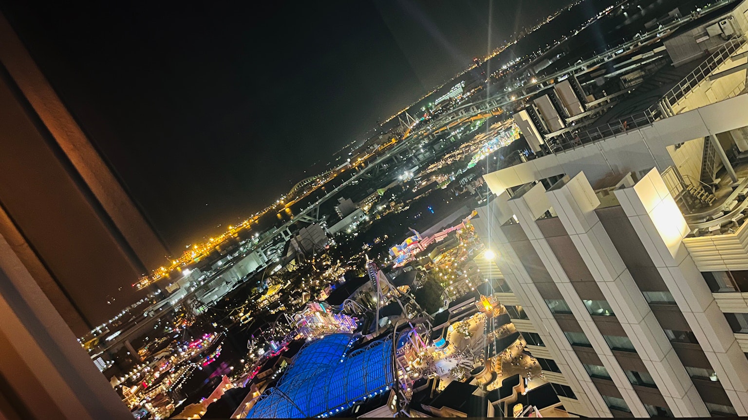 Vista notturna da un grattacielo luci della città e superficie d'acqua blu
