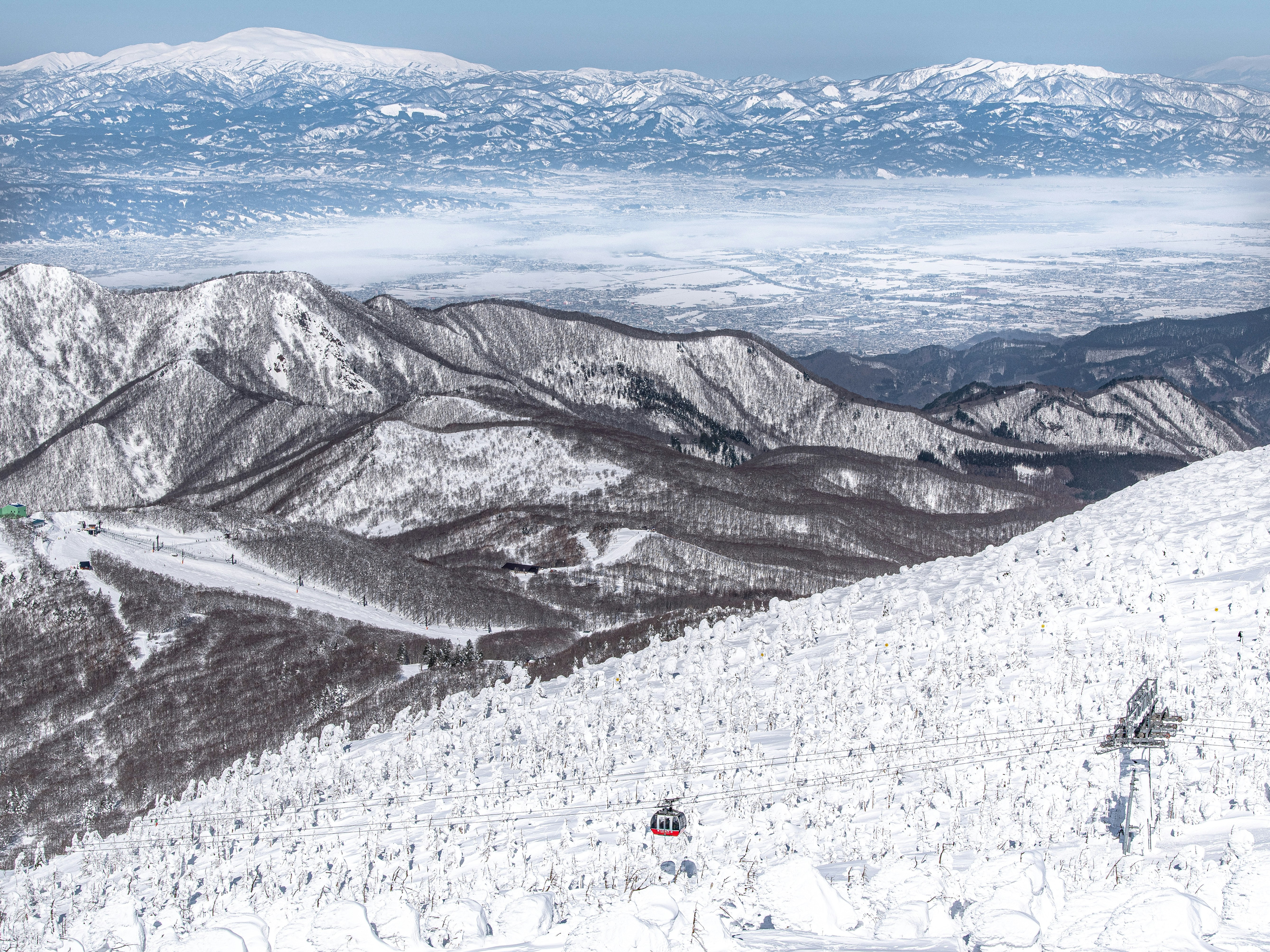 Snow-covered mountains with a ski lift in the foreground