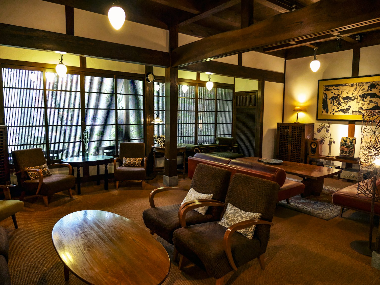 Interior de sala japonesa tradicional con muebles de madera grandes ventanas y luz cálida