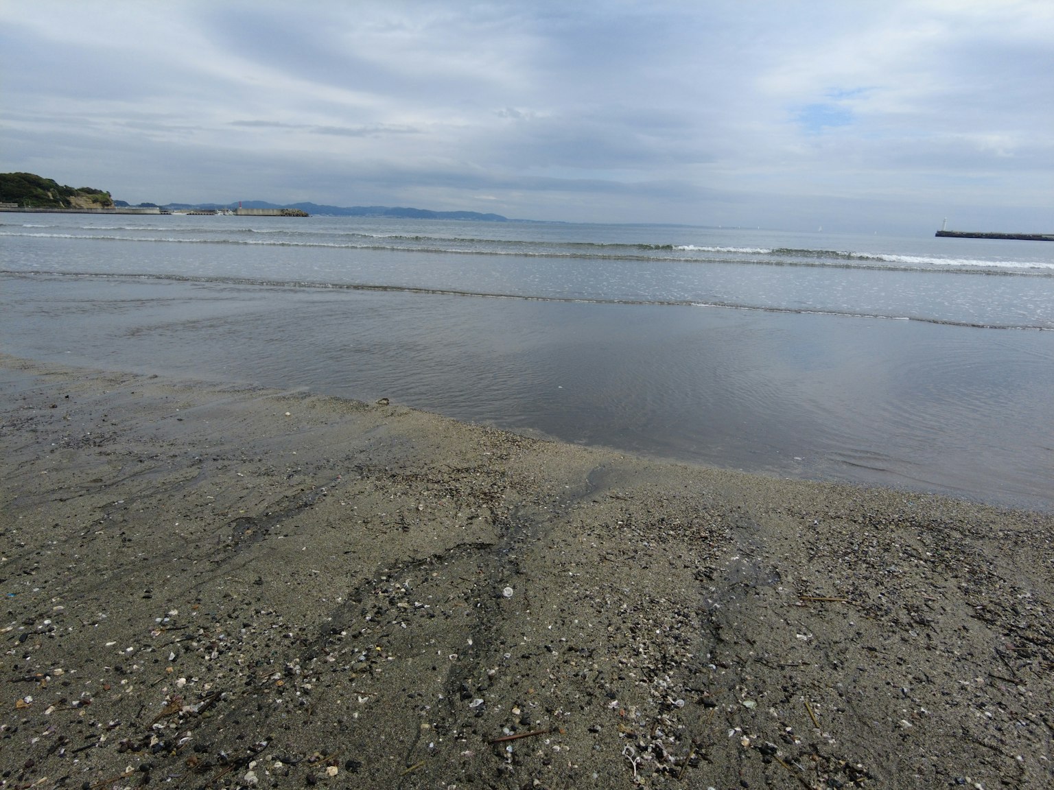 Coastal landscape with sandy beach and gentle waves