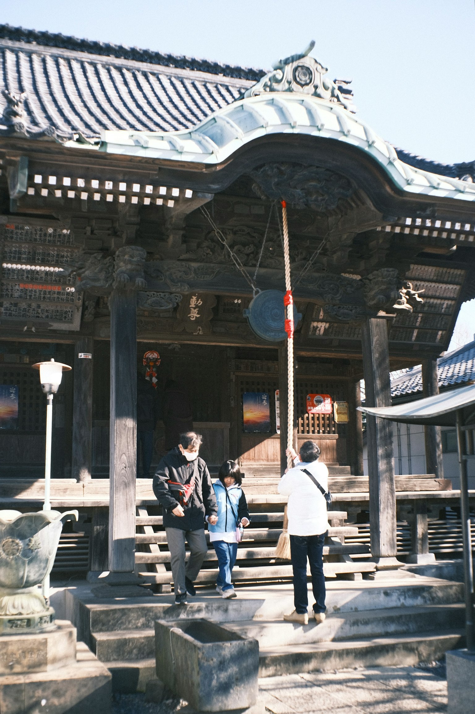 People standing at the entrance of an old temple showcasing traditional architectural style