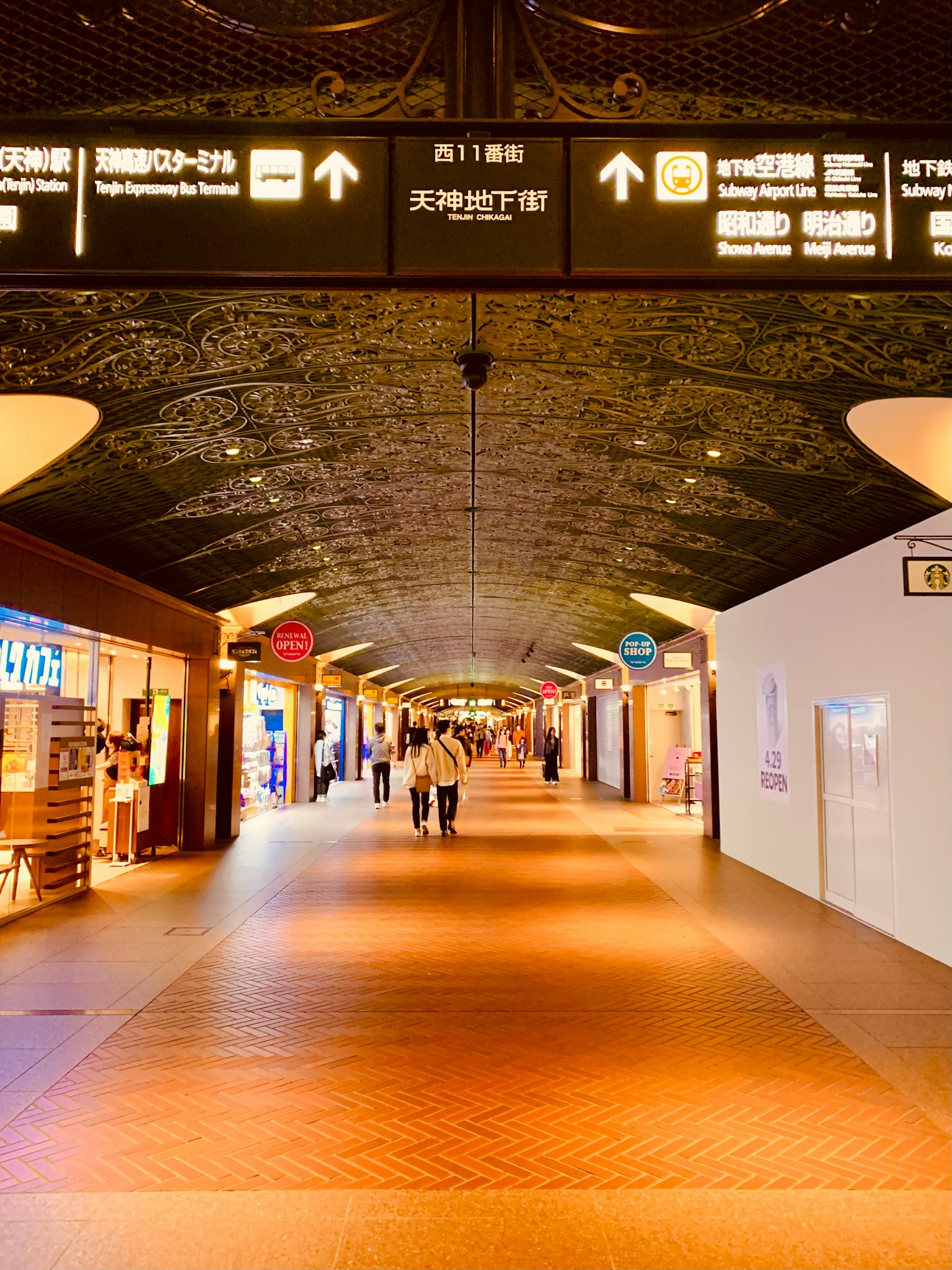 Corredor espacioso del aeropuerto con personas caminando Iluminación brillante y señales visibles