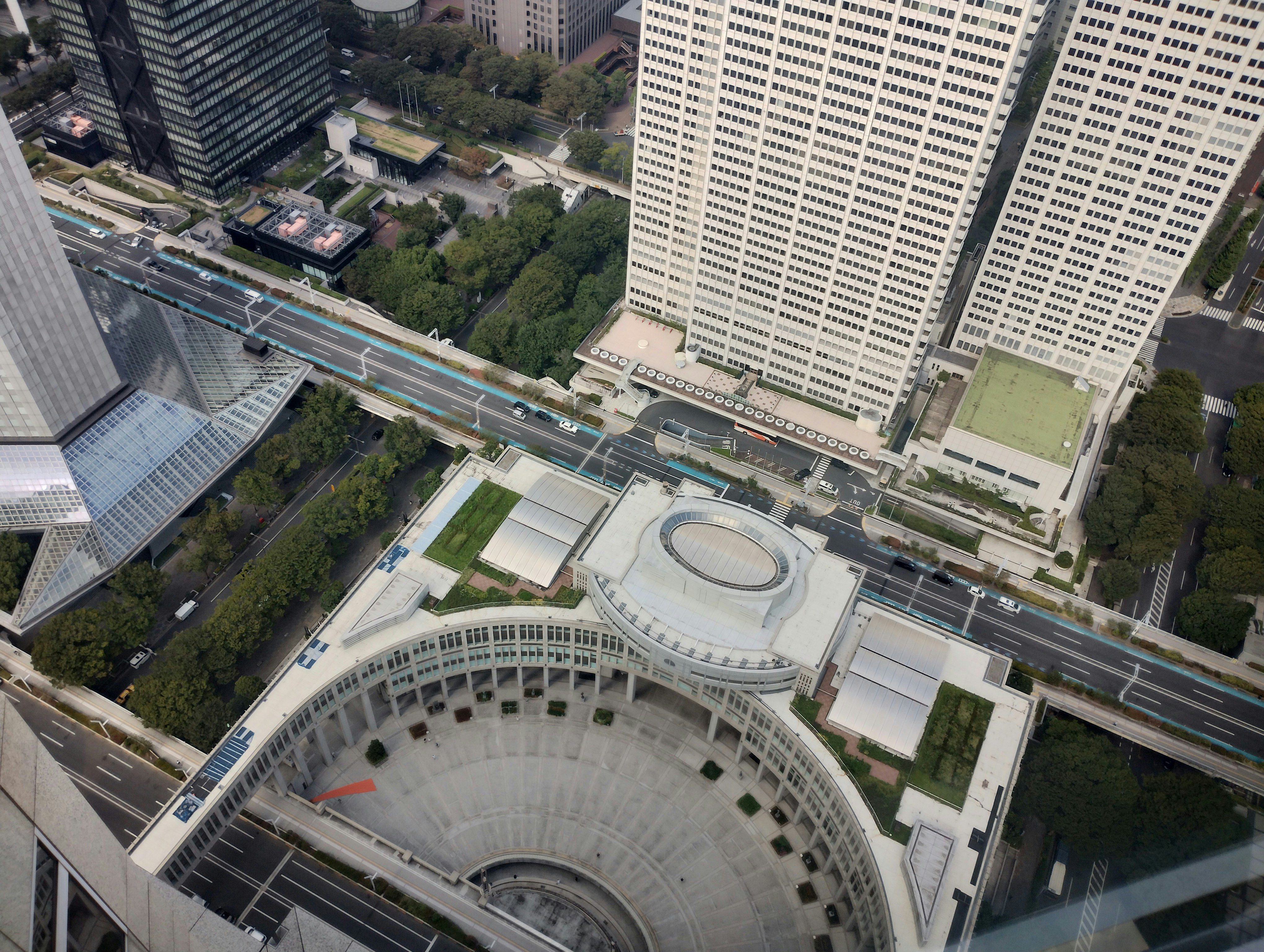 a circular rooftop plaza and walkways surrounded by skyscrapers