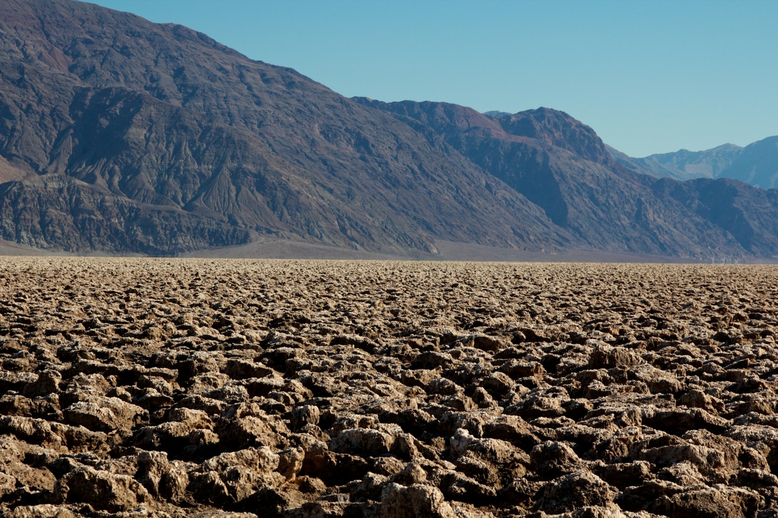 ภูมิประเทศแห้งแล้งของหุบเขามรณะและภูเขาไกลๆ