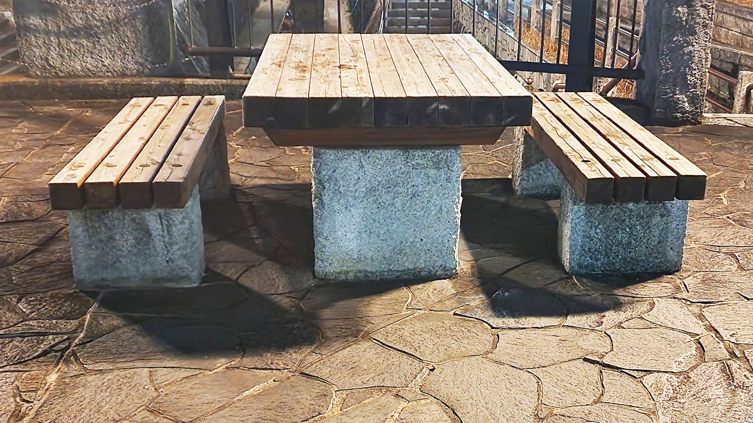 Outdoor seating area with wooden table and concrete benches