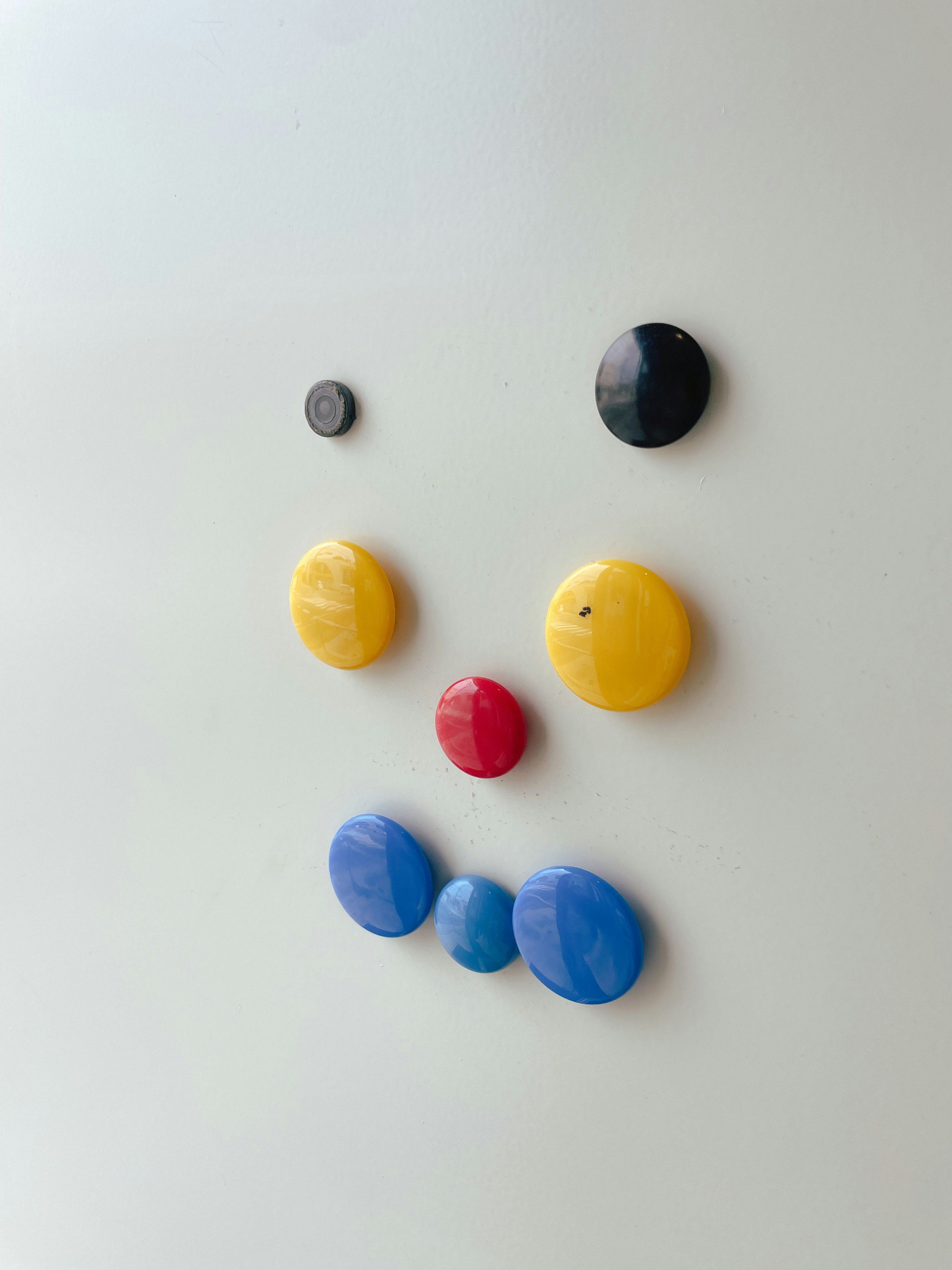 colorful magnetic face arranged on a white background