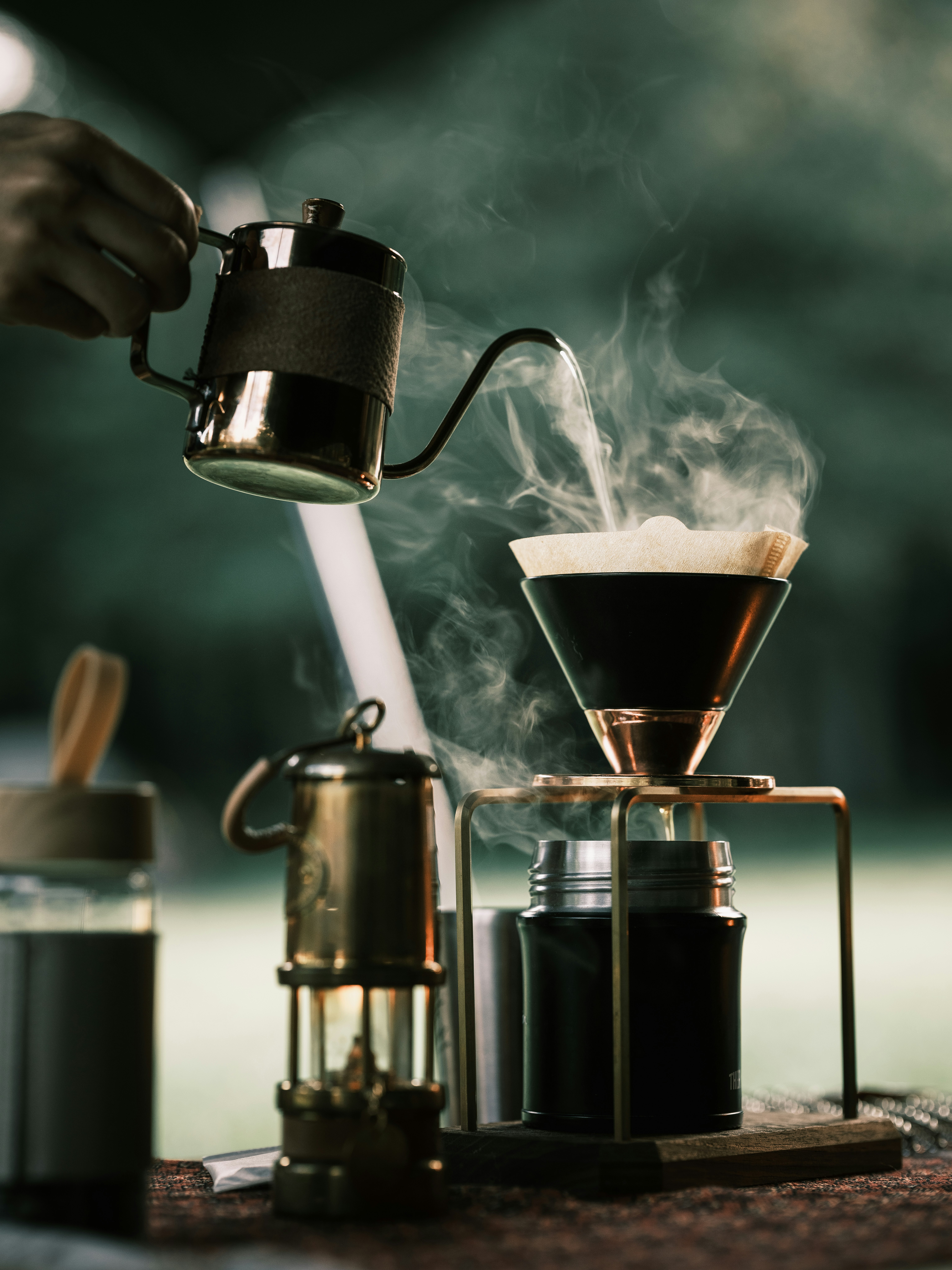 camp coffee brewing setup with steaming drip