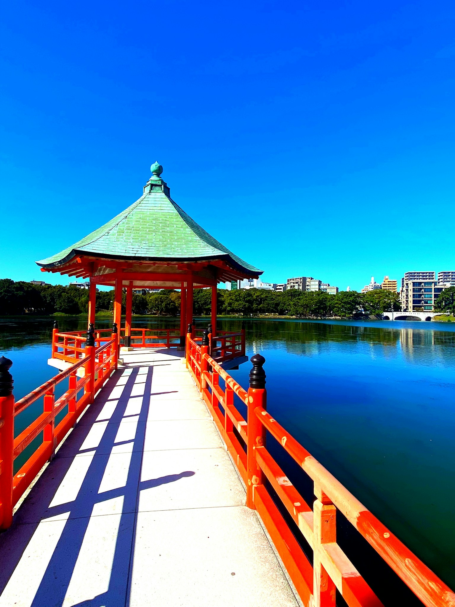 Beautiful view of a red bridge and pavilion over a lake