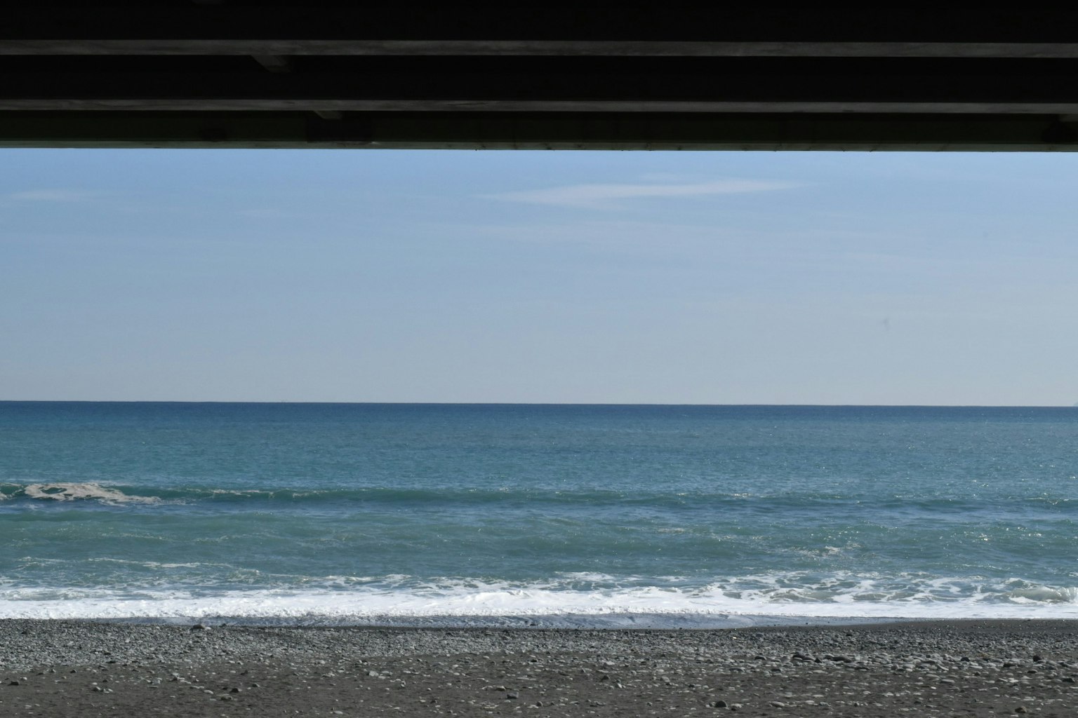 View of the sea and sky from under a structure