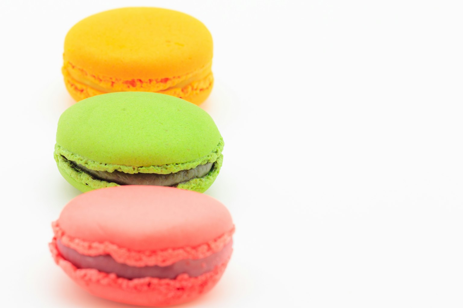 Three colorful macarons arranged in a row