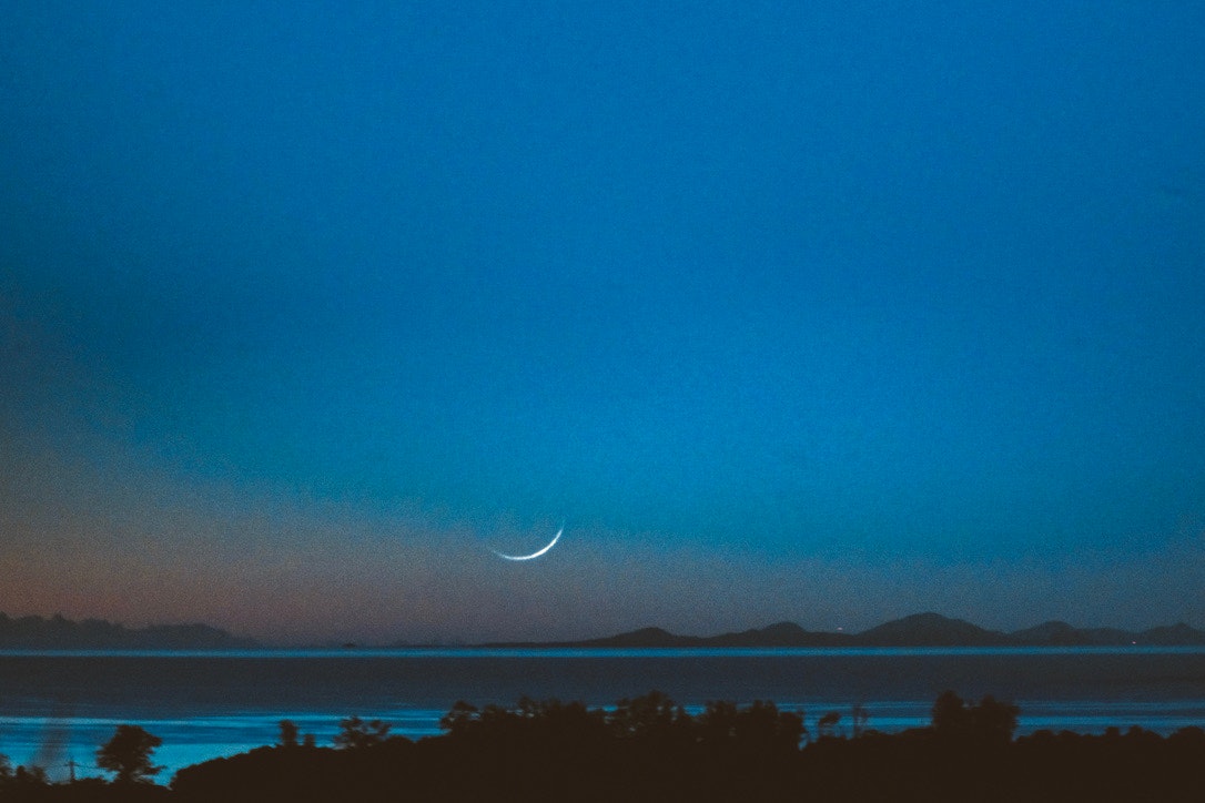 night seascape with the moon over the horizon