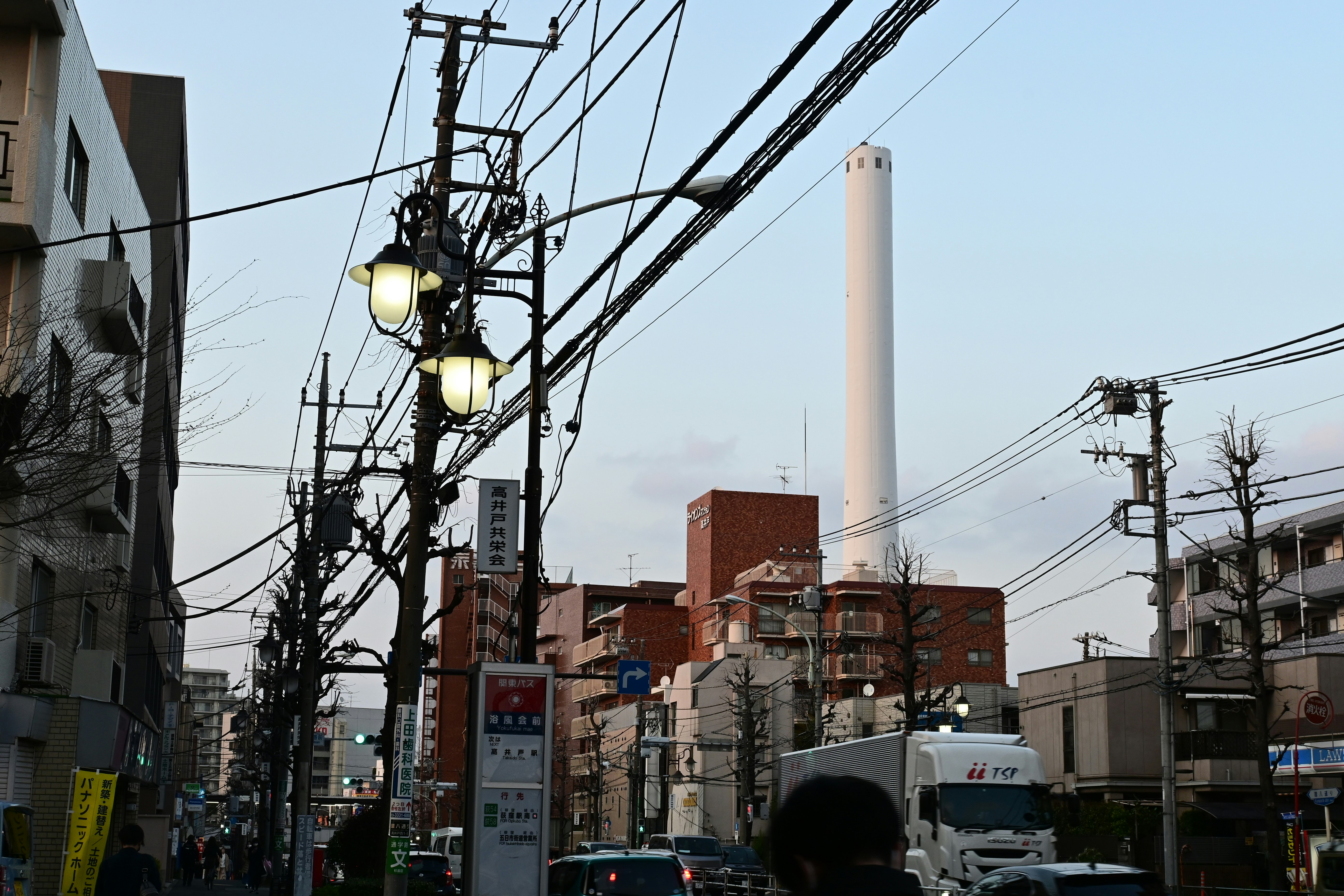 urban intersection scene with overhead power lines and streetlights