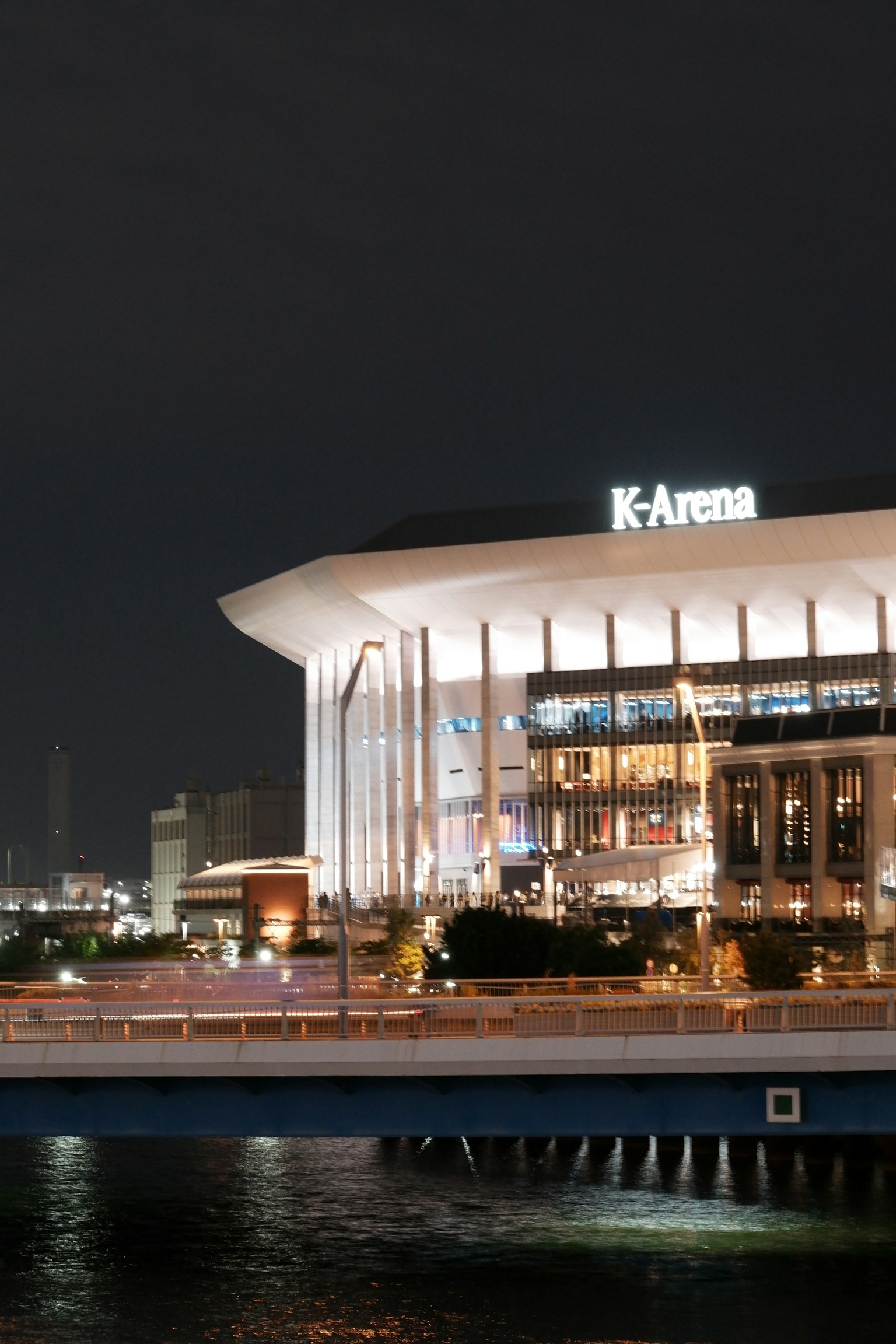 Night view of K-Arena showcasing its unique architecture and surrounding area