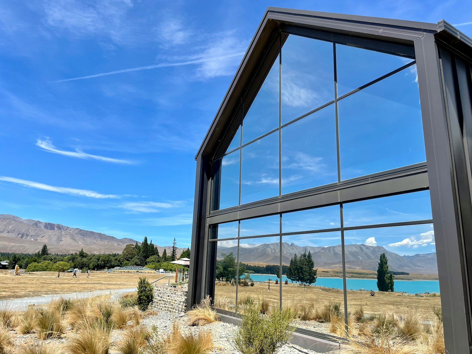 Modern building with large glass windows overlooking a natural landscape