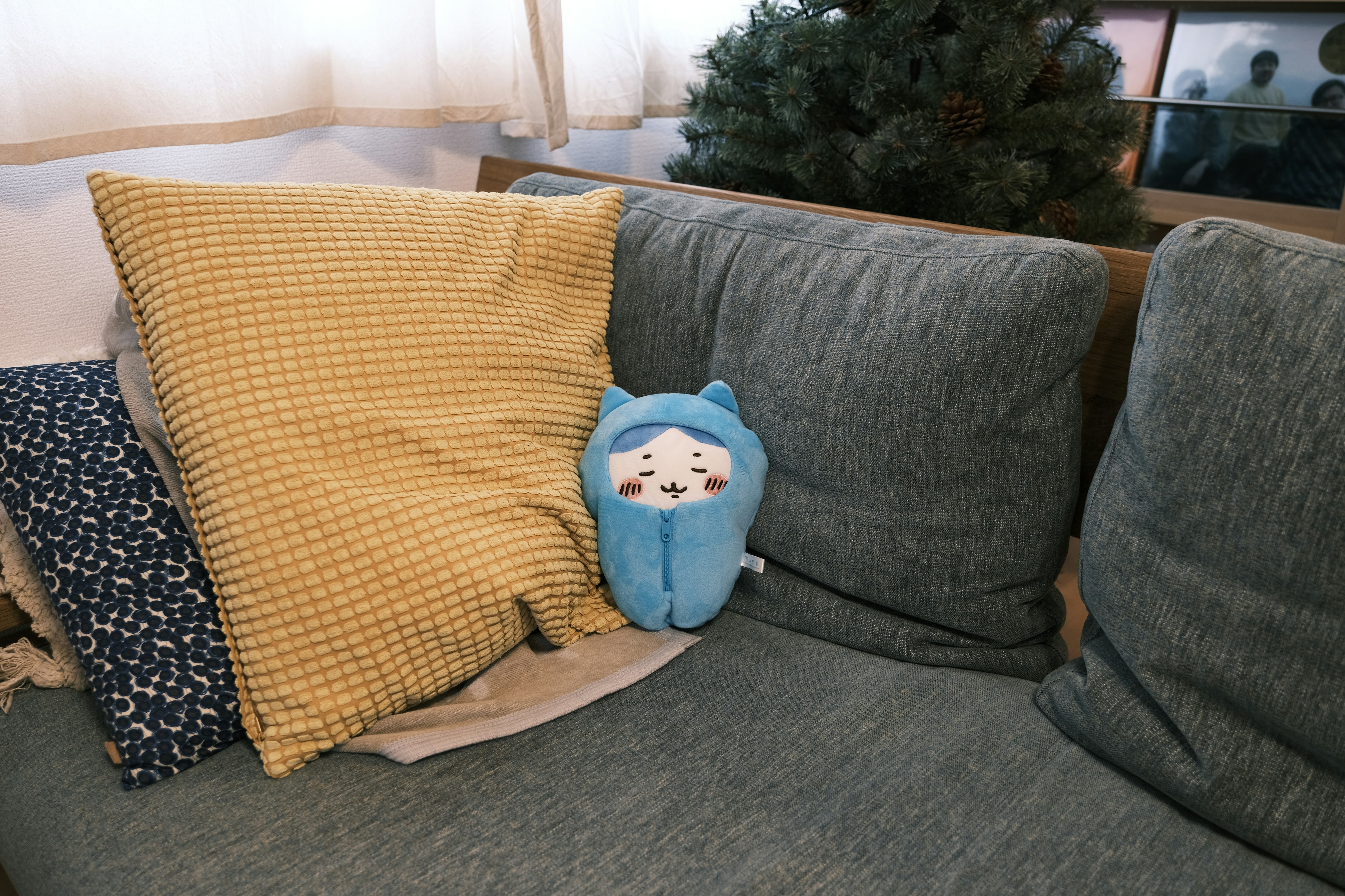 living room sofa with cushions and a plush toy
