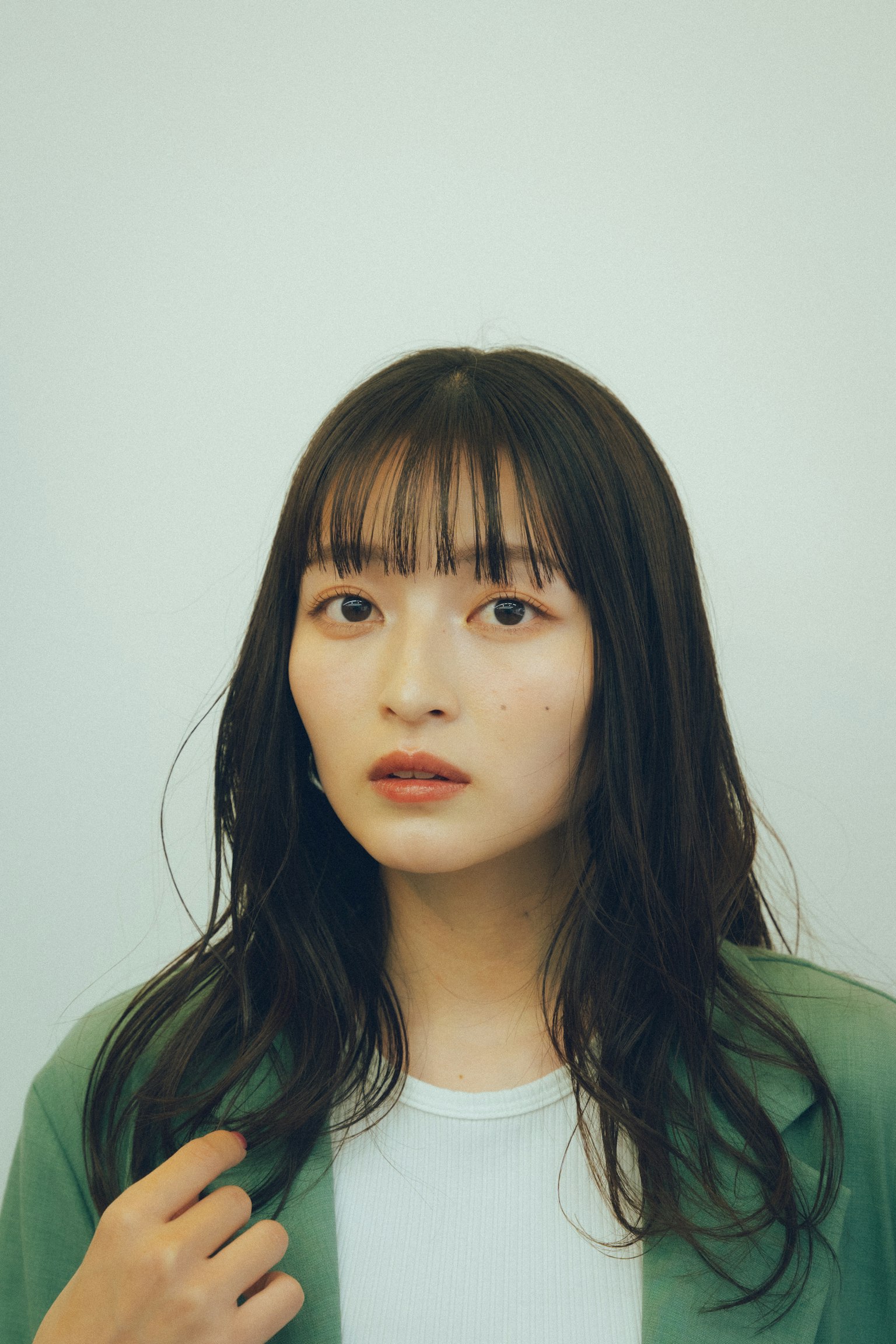 穿着绿色夹克的长发女性肖像
