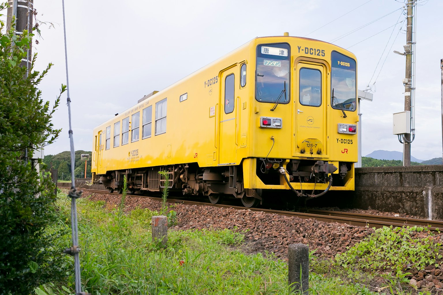 A yellow train running on the tracks