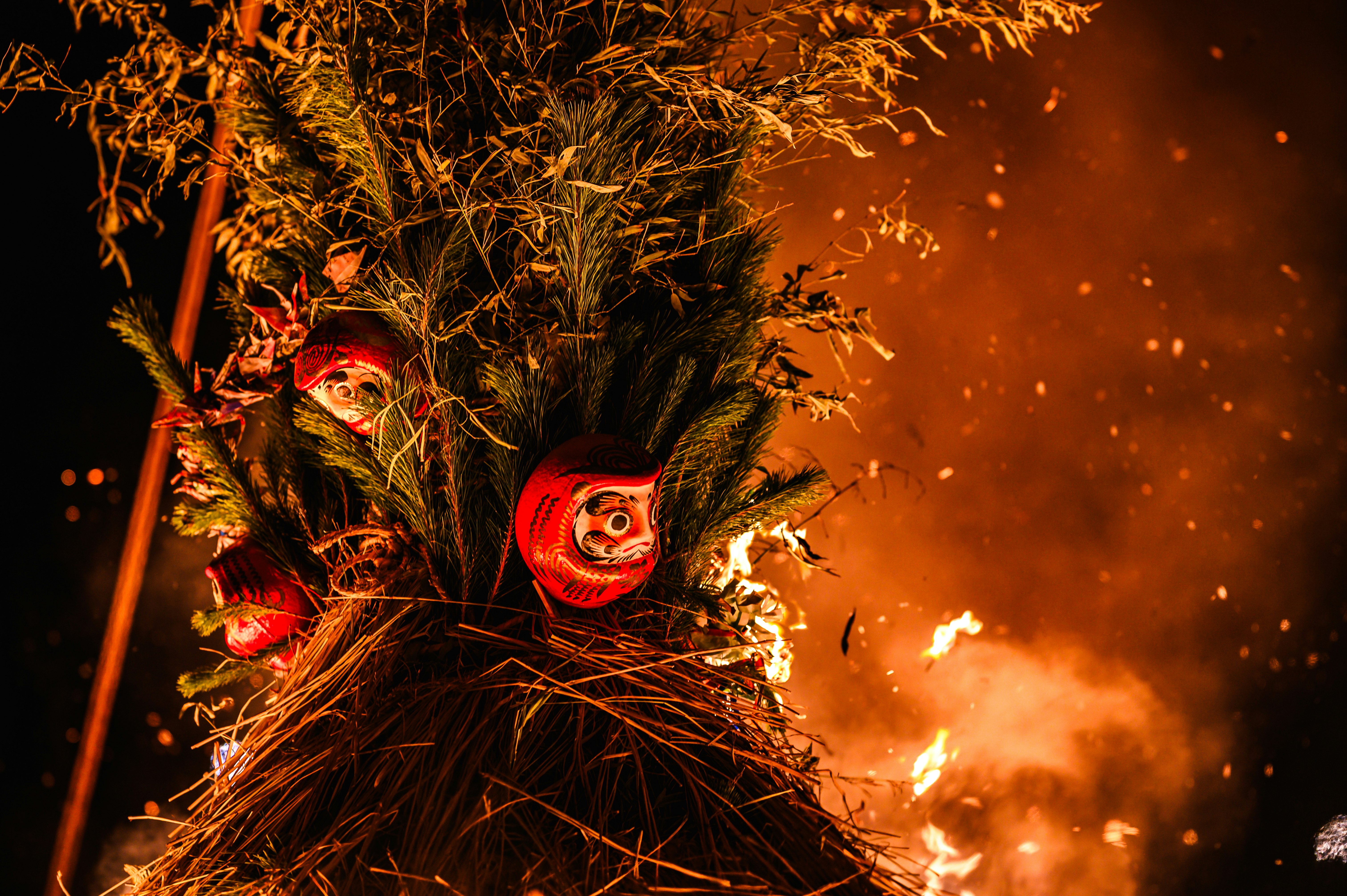 straw effigy burning amid flames and sparks