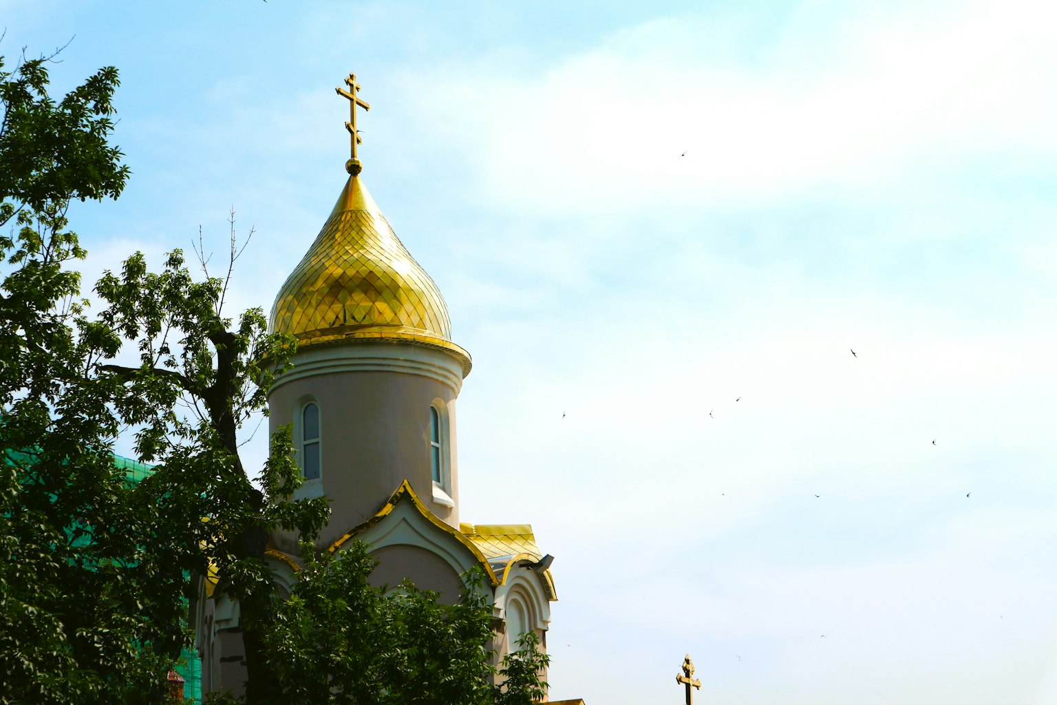 Church tower with a golden dome against a blue sky
