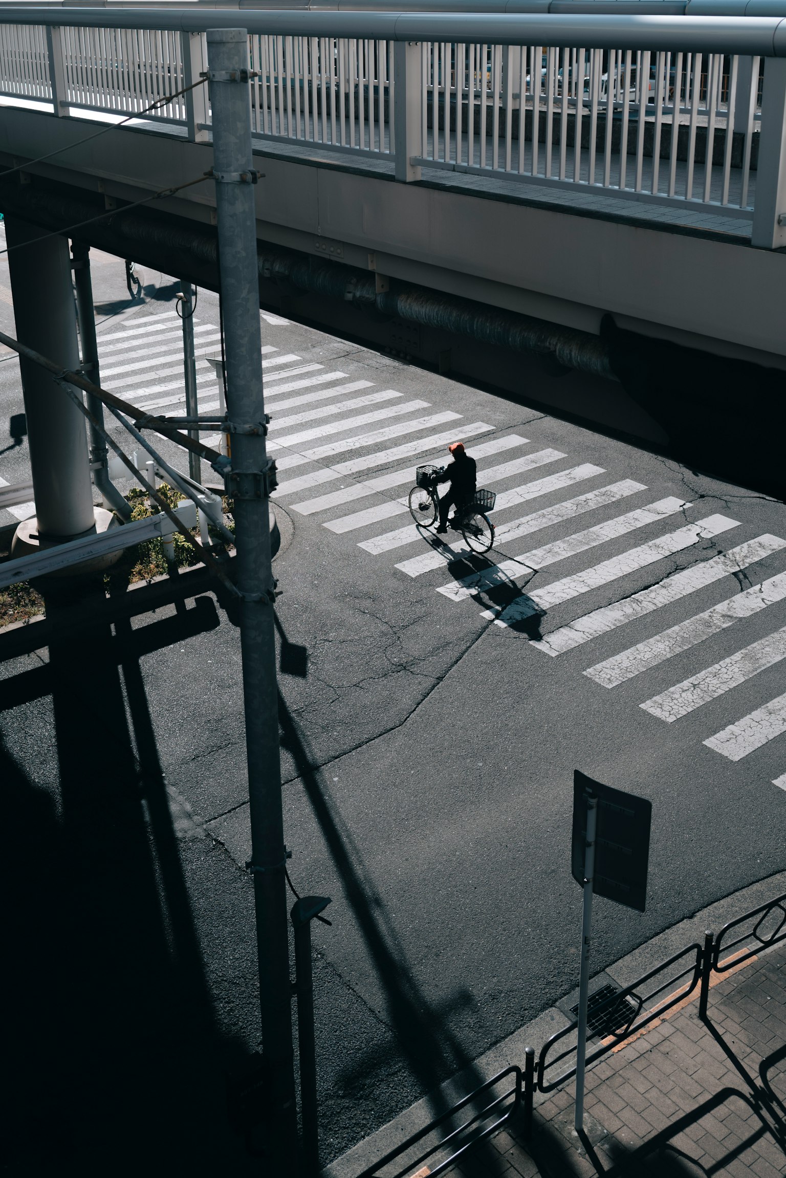 Bicyclist crossing a street with shadows