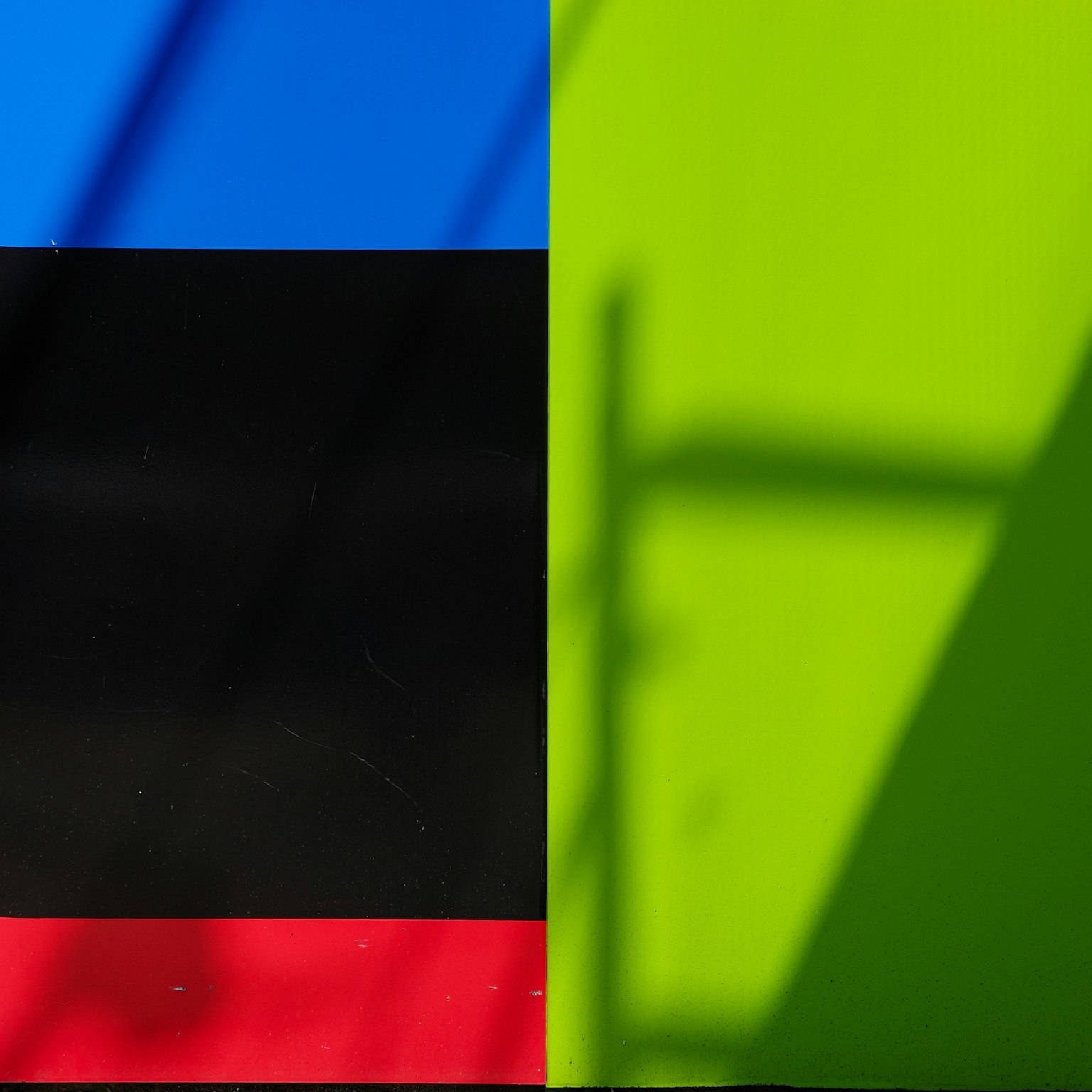 Kontrast von blauen und grünen Wänden mit schwarzen und roten Streifen