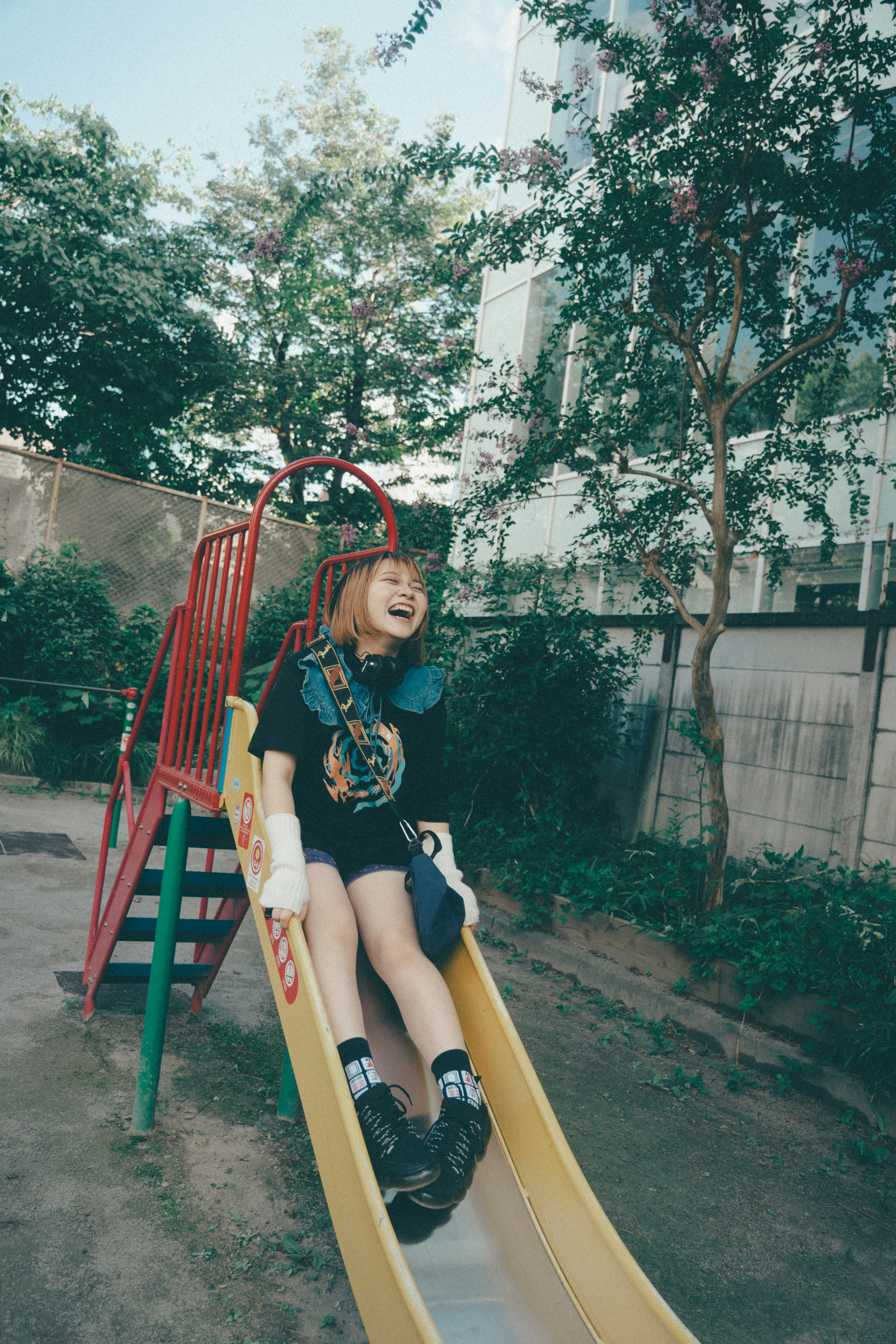 smiling child playing on a backyard slide