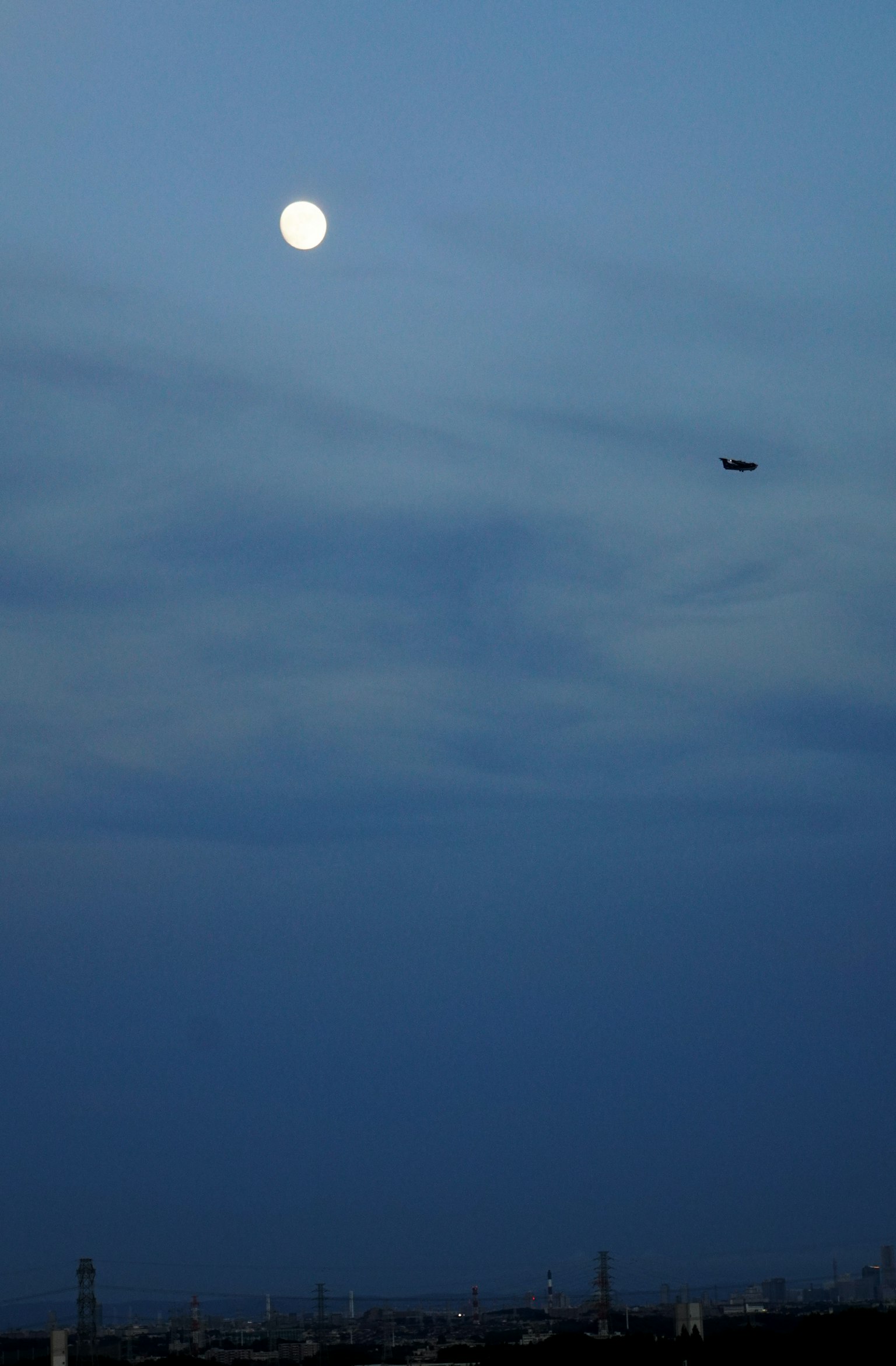 Bright moon in the night sky with clouds