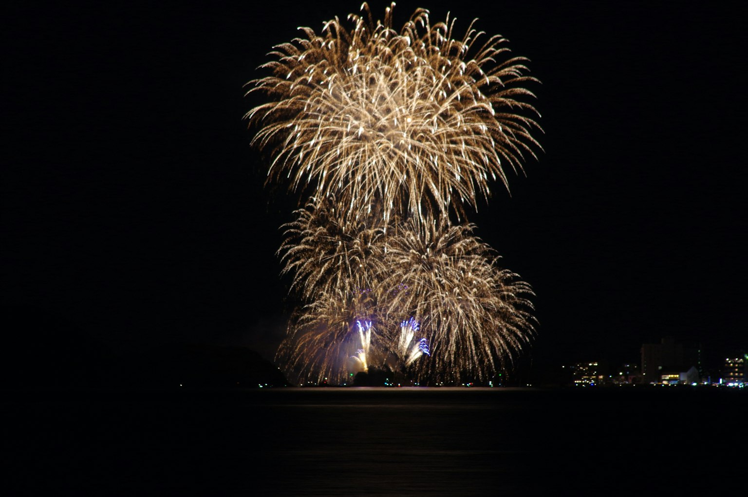Beautiful scene of golden fireworks exploding in the night sky