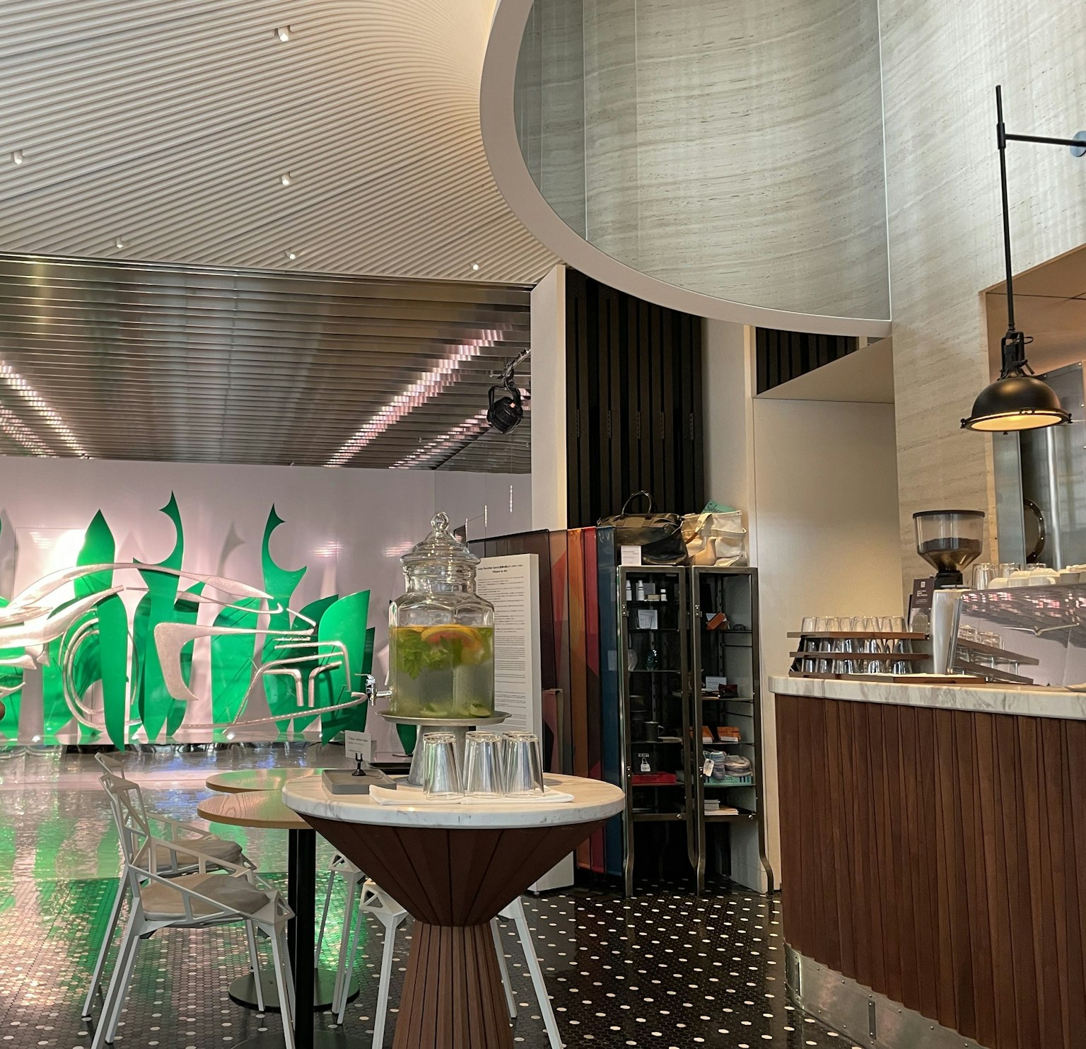 Modern cafe interior design with green decorative wall and stylish furniture