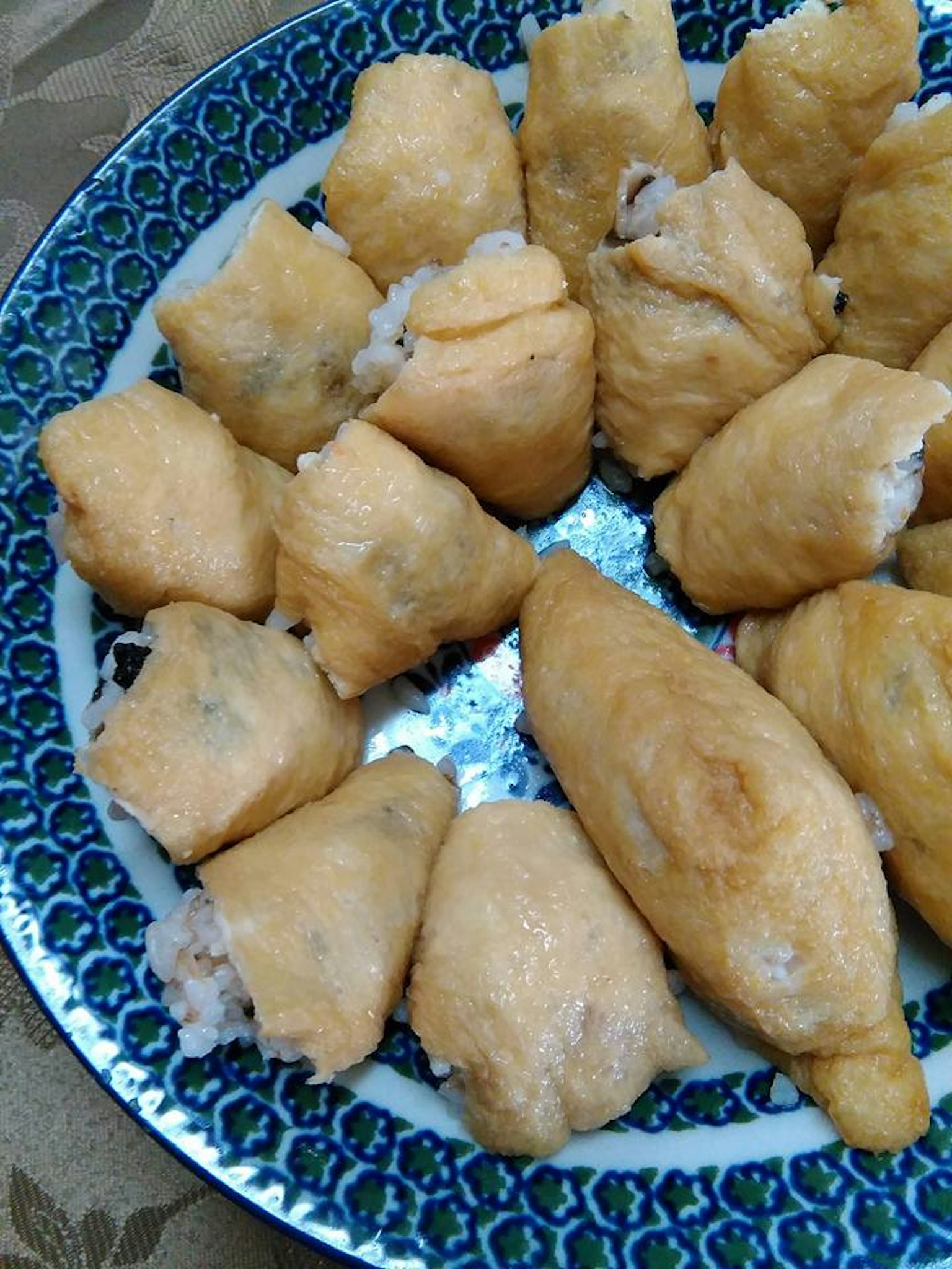 Close-up of a plate of fried dumplings with a golden exterior and white filling
