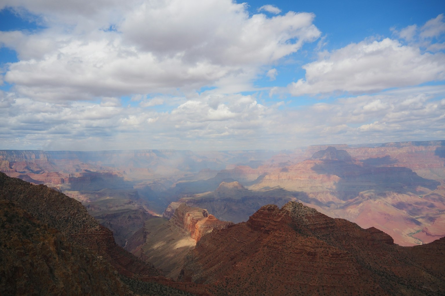 Paysage vaste du Grand Canyon ciel bleu avec des nuages blancs formations rocheuses rougeâtres