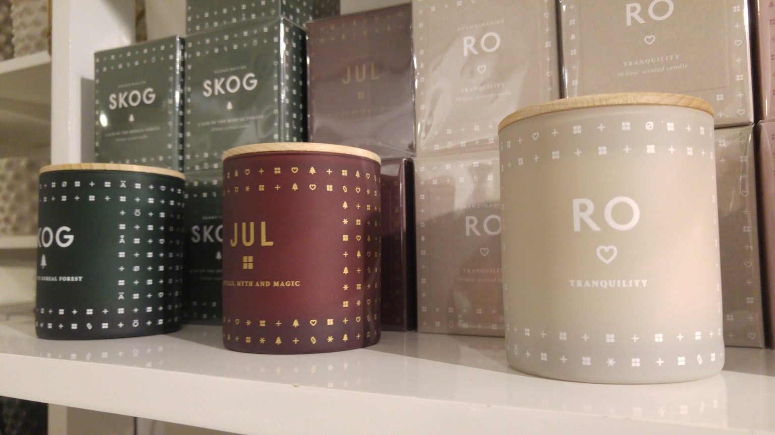 Display of candle containers and packages on a shelf