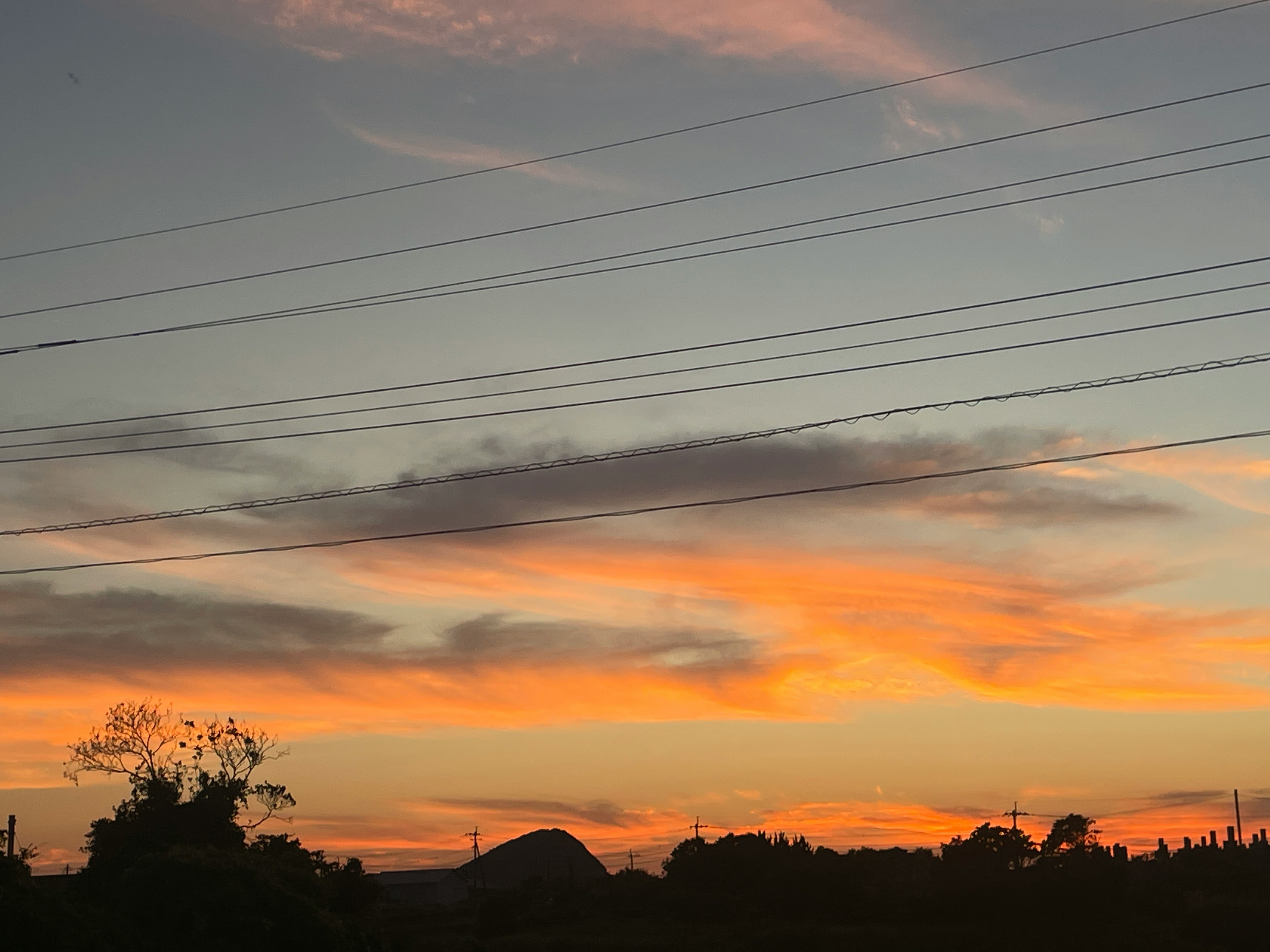 夕焼けの空に広がる雲とオレンジ色の光