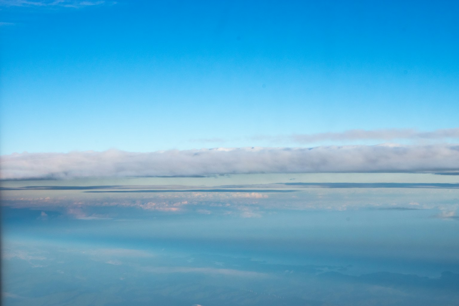 Vista panorámica del océano bajo un cielo azul claro con nubes