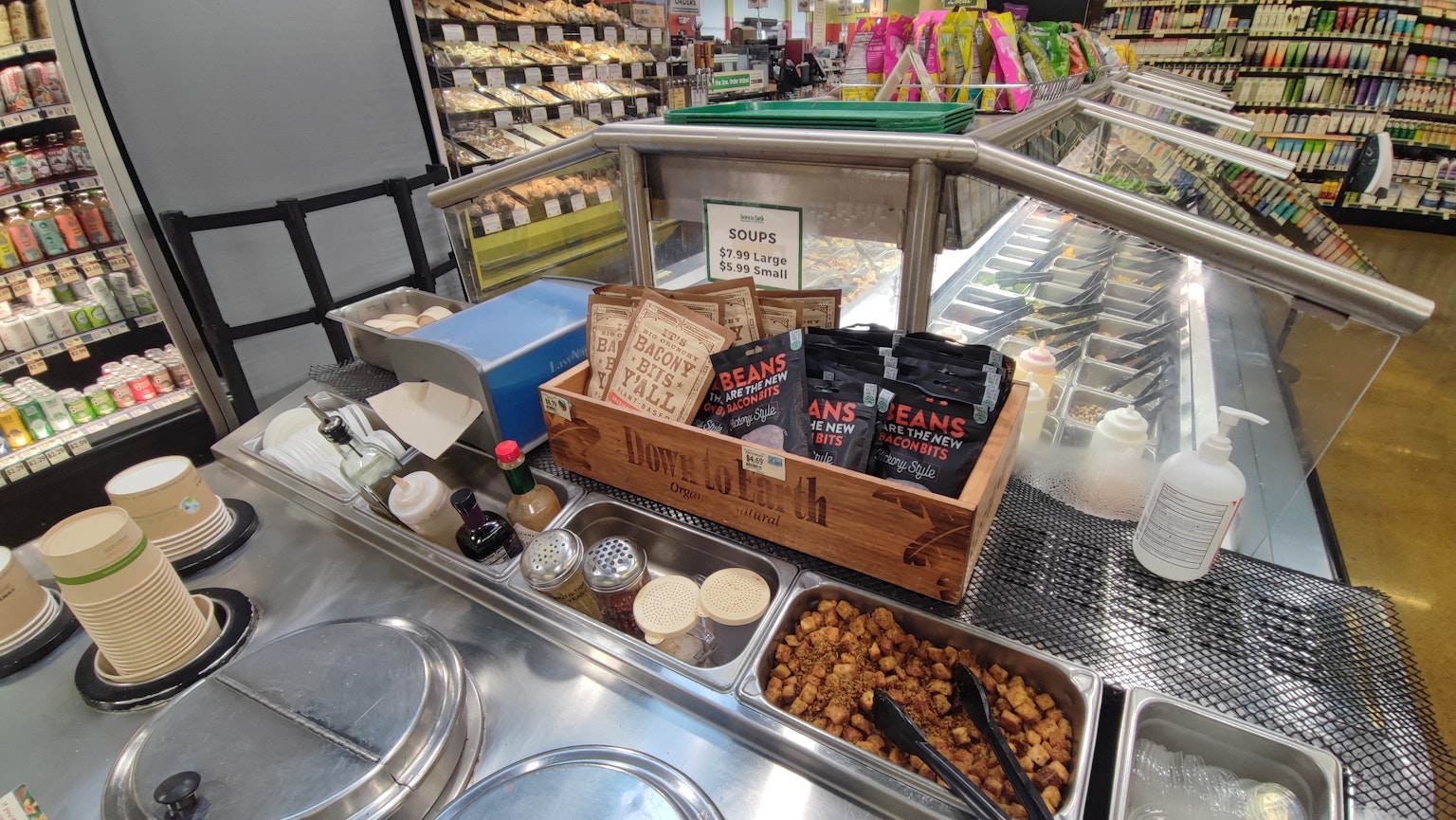 Ice cream toppings and packaged snacks displayed at a store counter