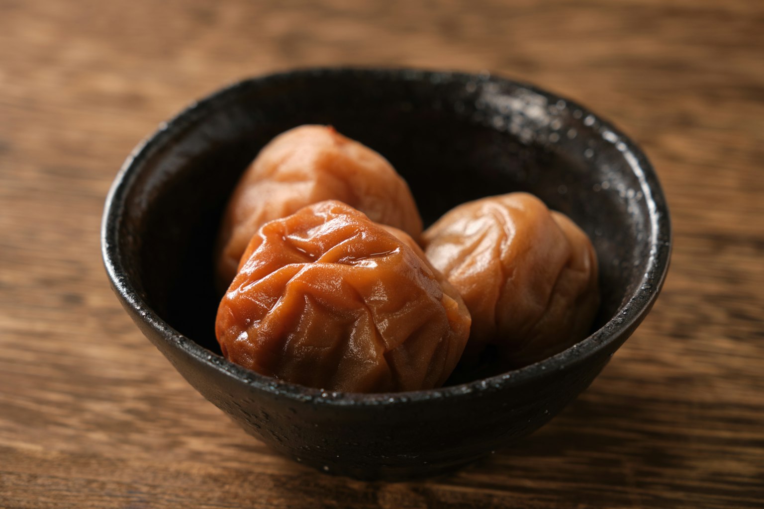 黑碗中腌制梅子的图片