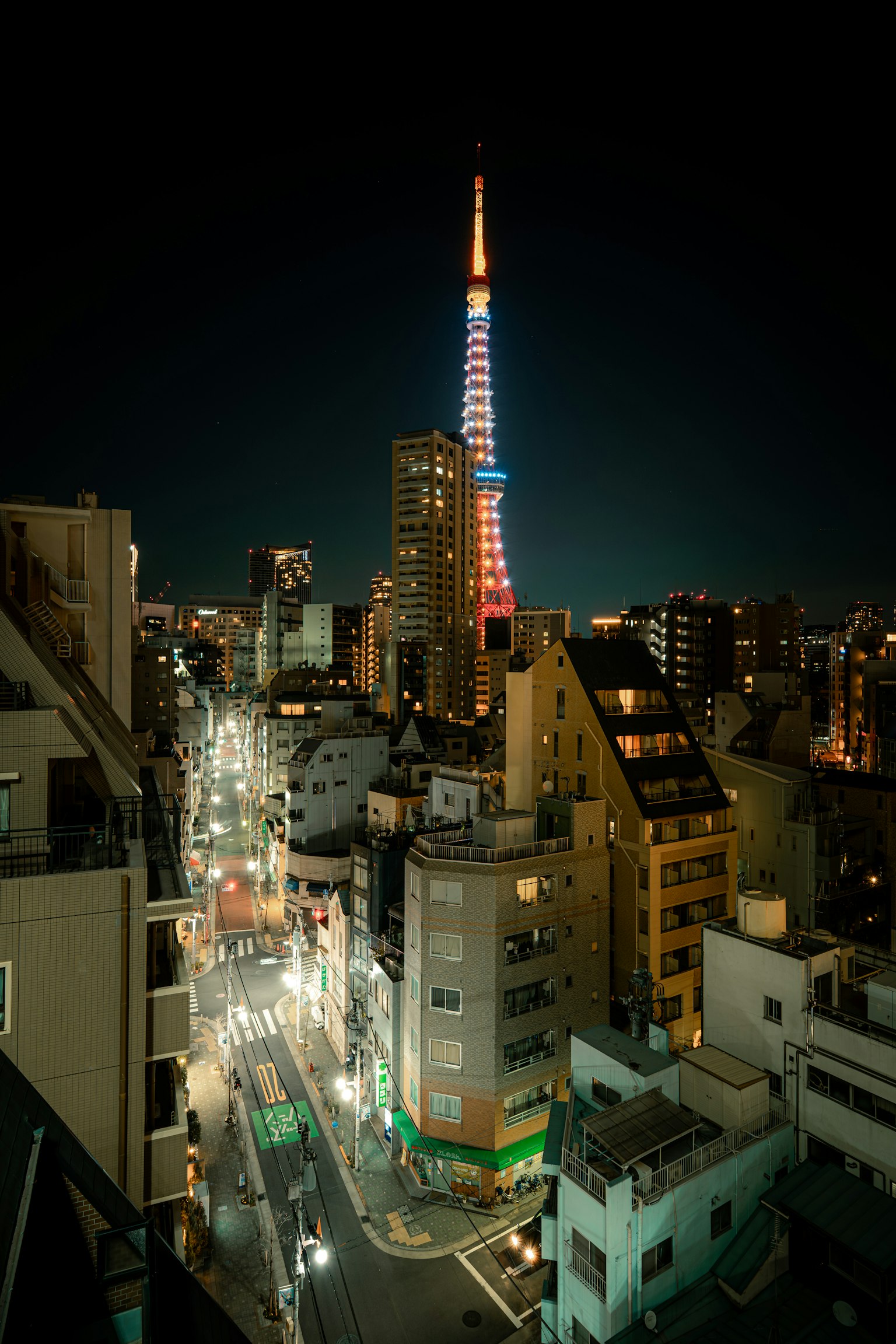 Tokyo Tower illuminated at night with cityscape