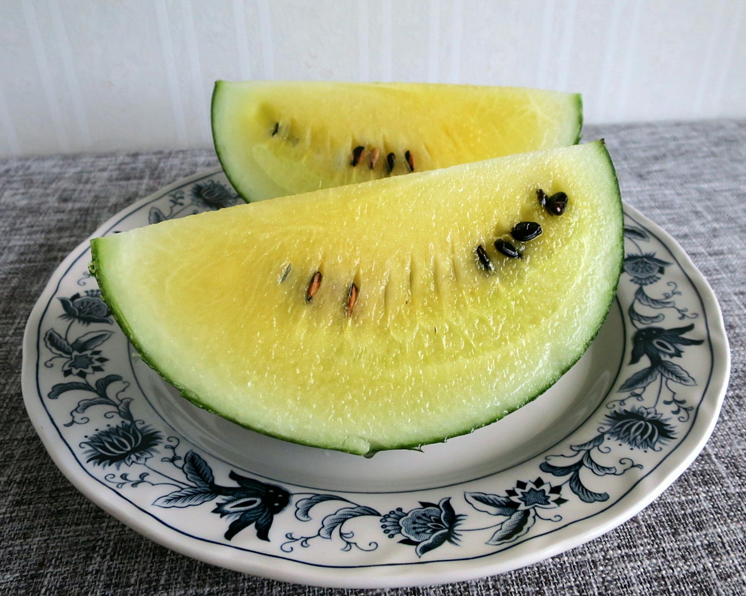 Yellow watermelon slices on a decorative patterned plate