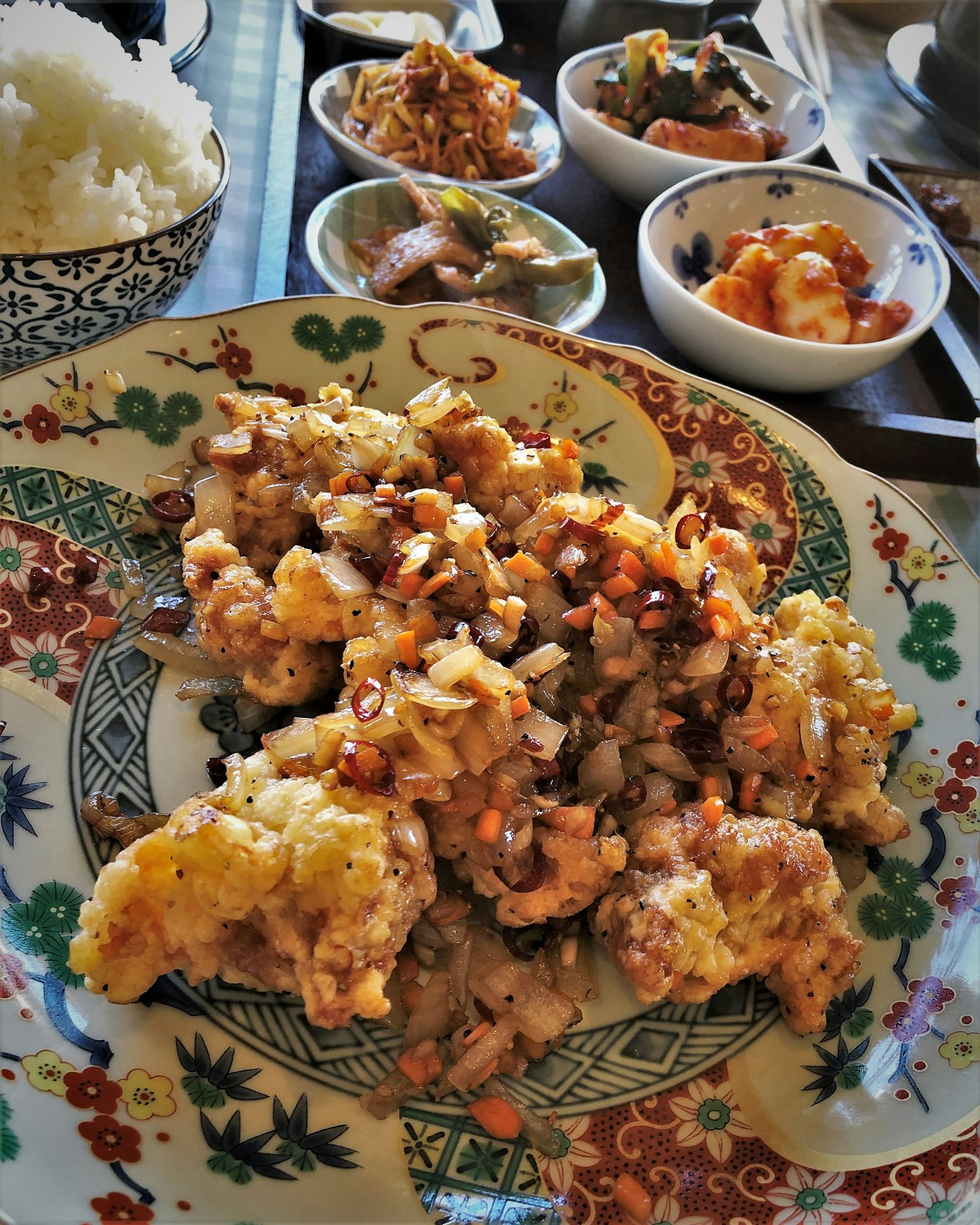 Colorful plate of delicious food with side dishes in small bowls