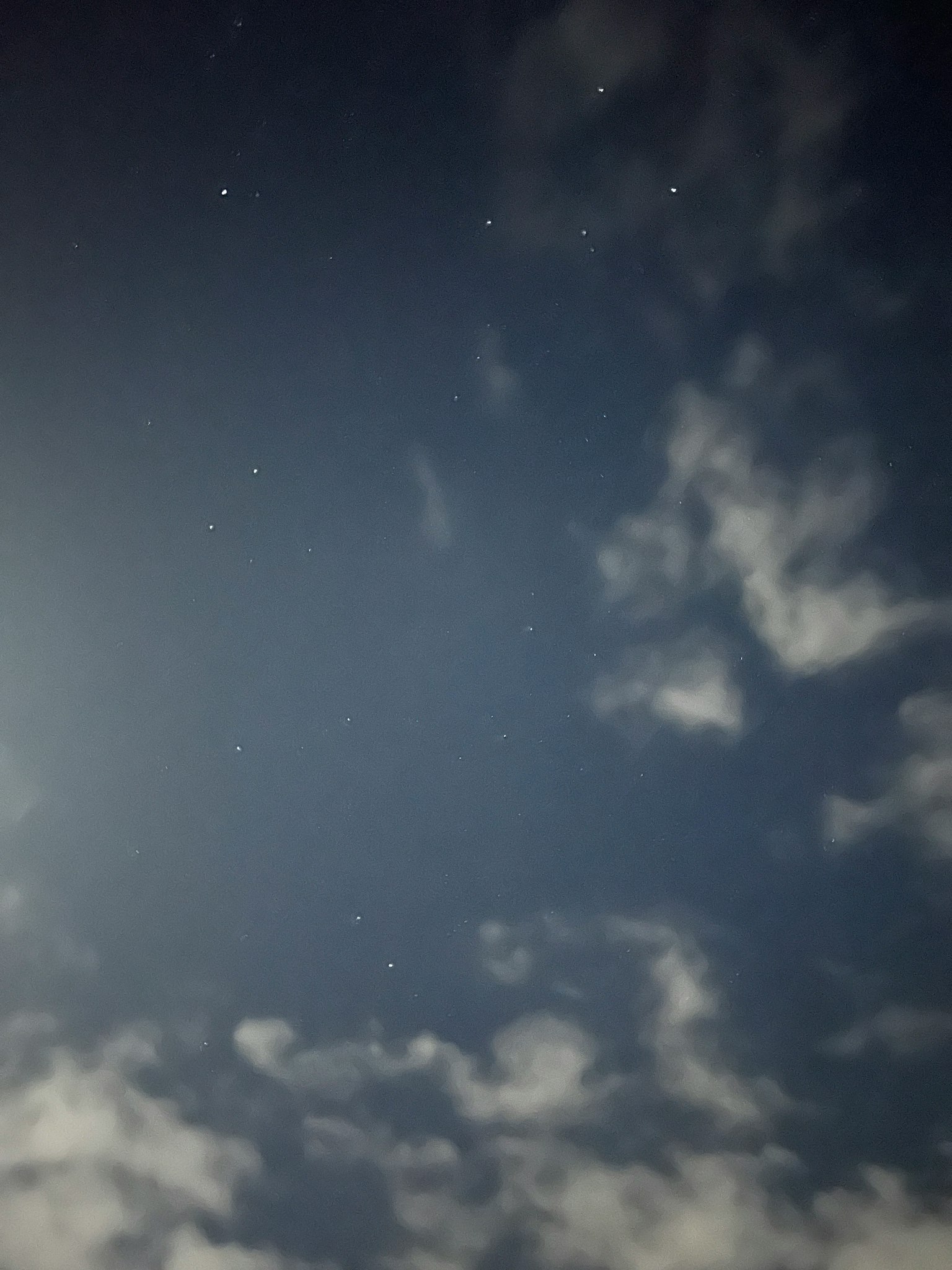 Scenic view of clouds and stars in the night sky