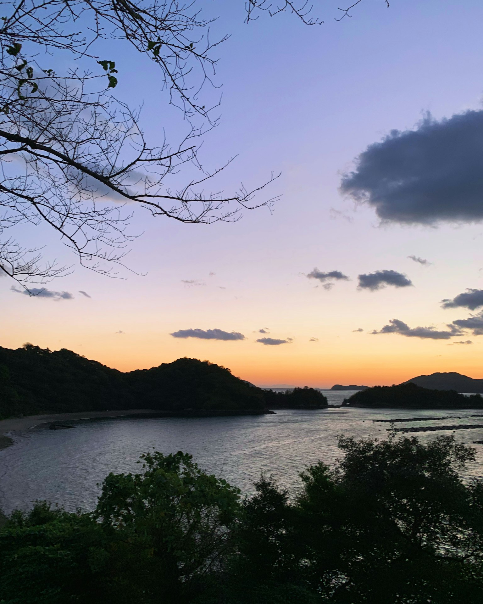 Tranquil lake and mountainous scenery at sunset