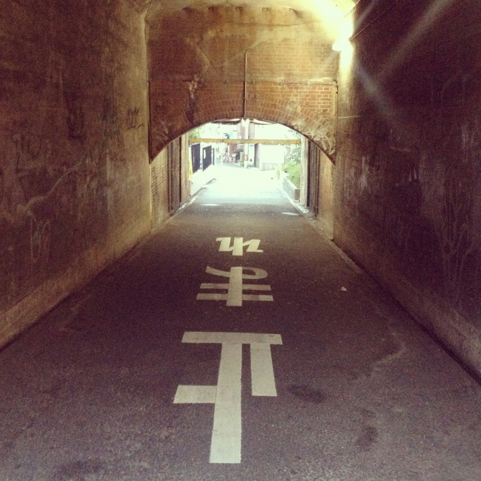 Blick auf einen Tunnel mit einer Straße, die durch weiße Linien markiert ist