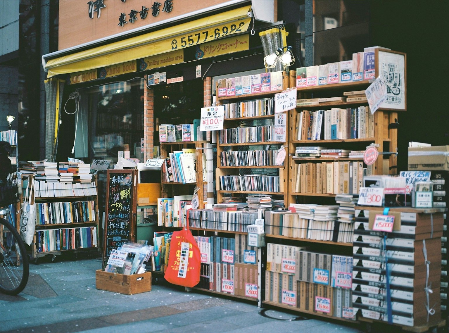 Exterior of a secondhand bookstore with shelves of books