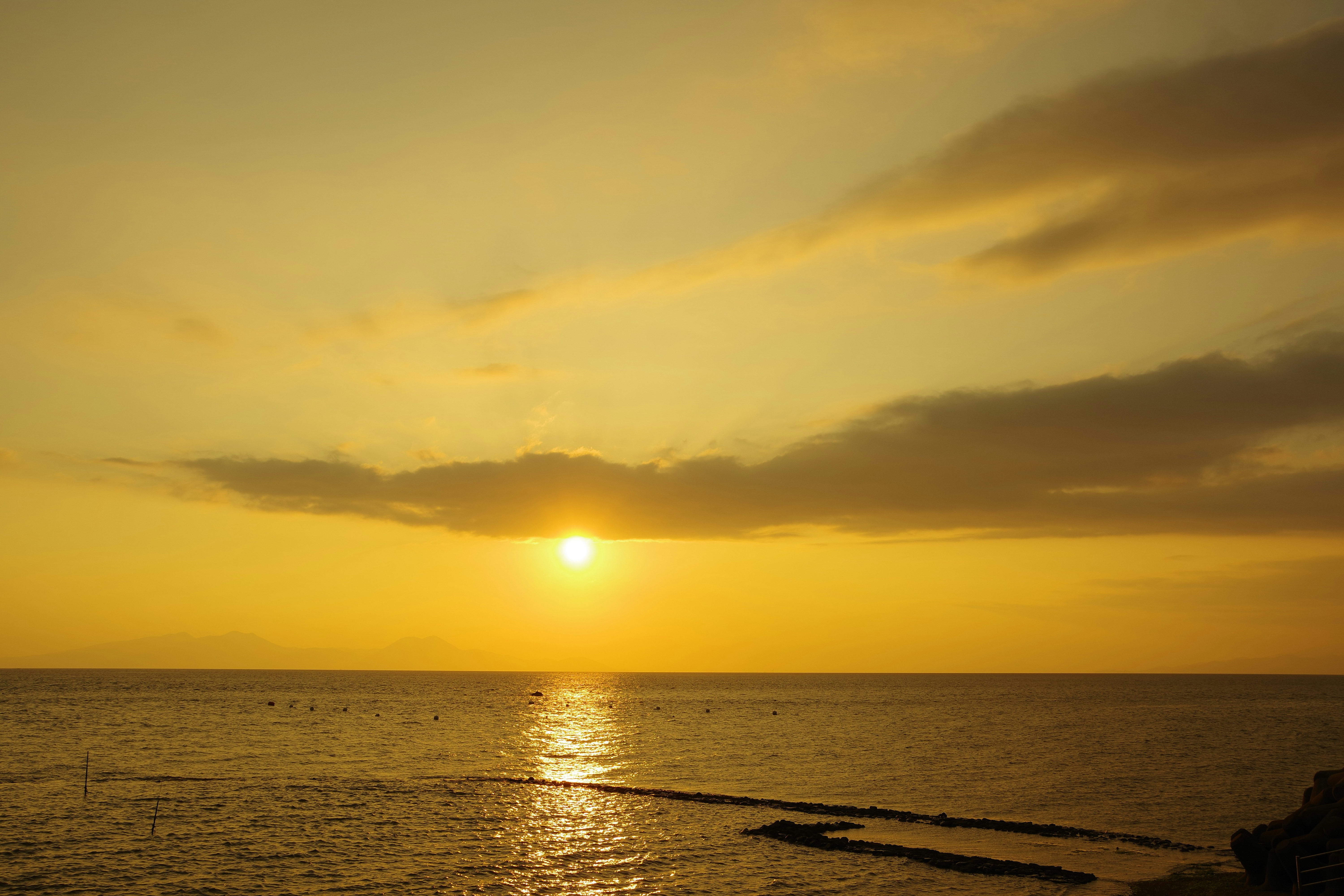 Seaside horizon at sunset with golden light
