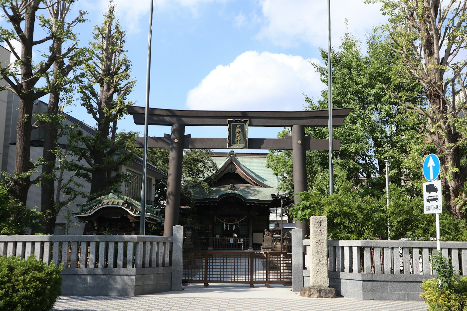 Torii gate of a shrine with lush greenery in a serene setting