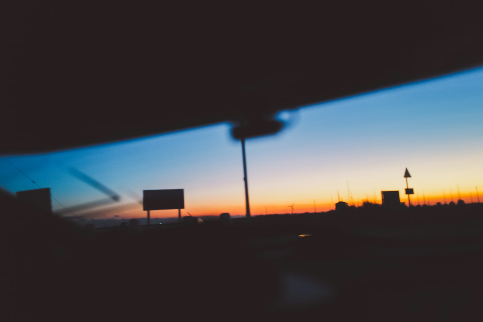 View through a car window showcasing a vibrant sunset