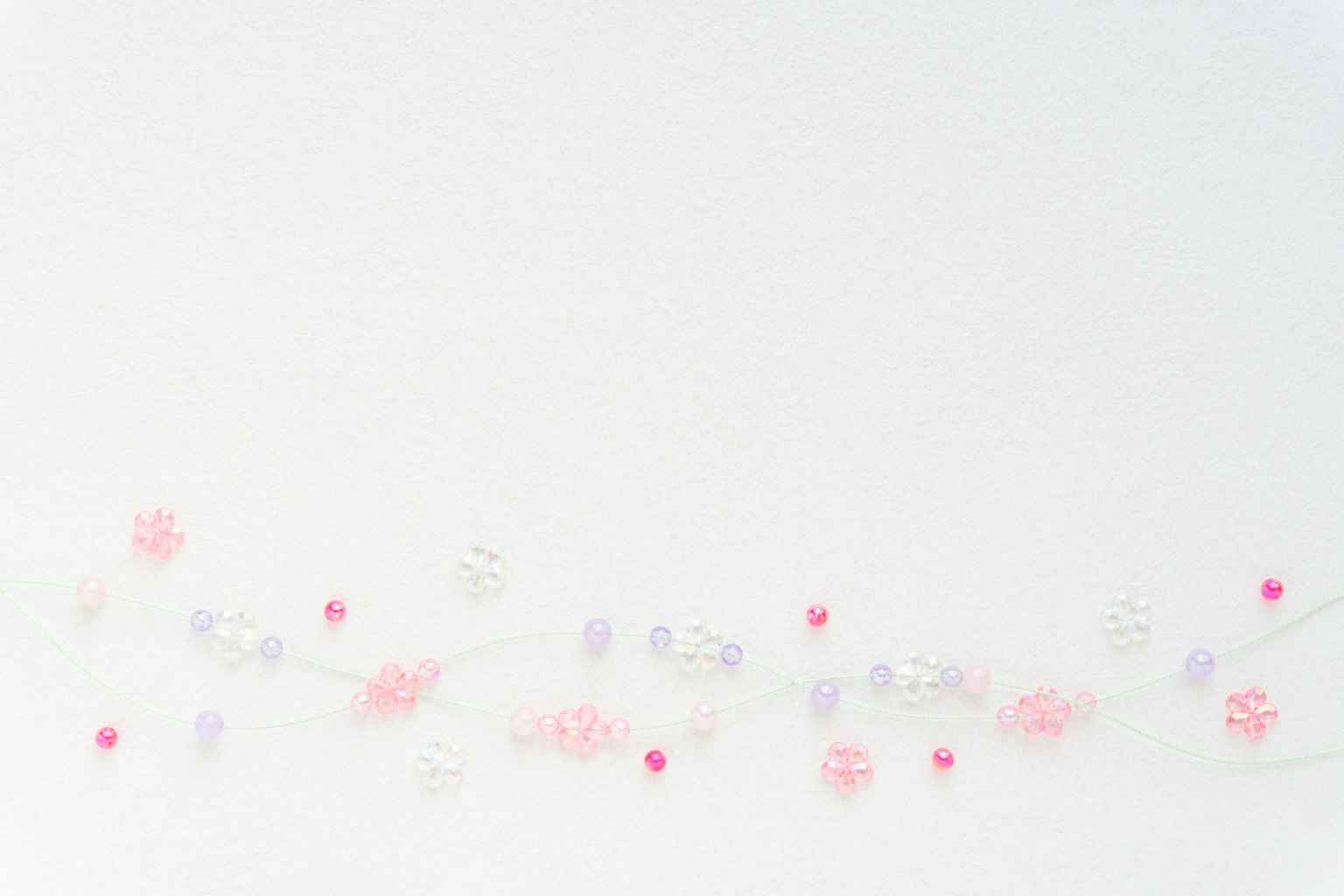 Decorative image featuring pink and purple ornaments against a white background